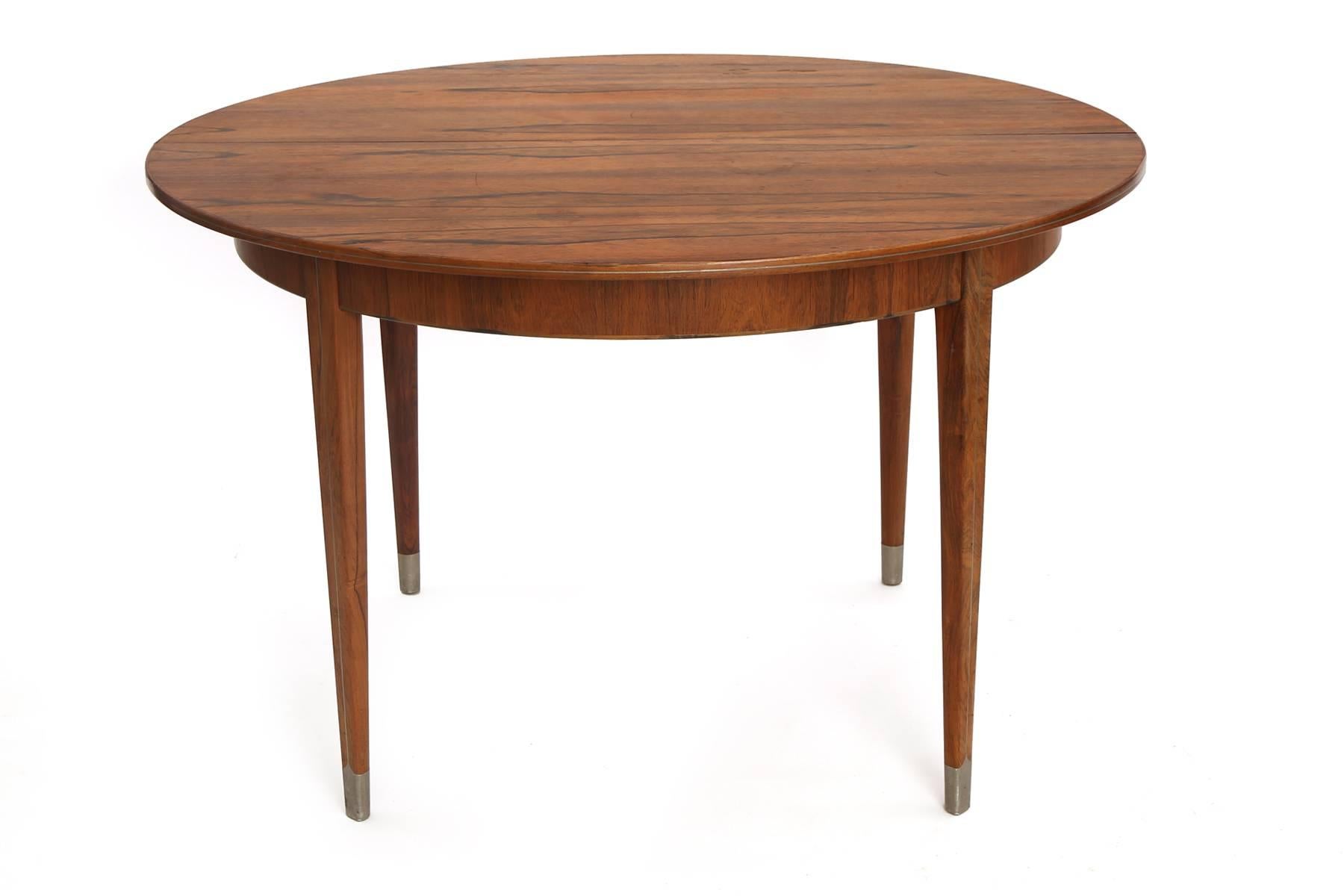 Rare rosewood and pewter dining table by Georg Kofoed, circa late 1930s. This all original example has a beautifully grained rosewood top and extends from 49