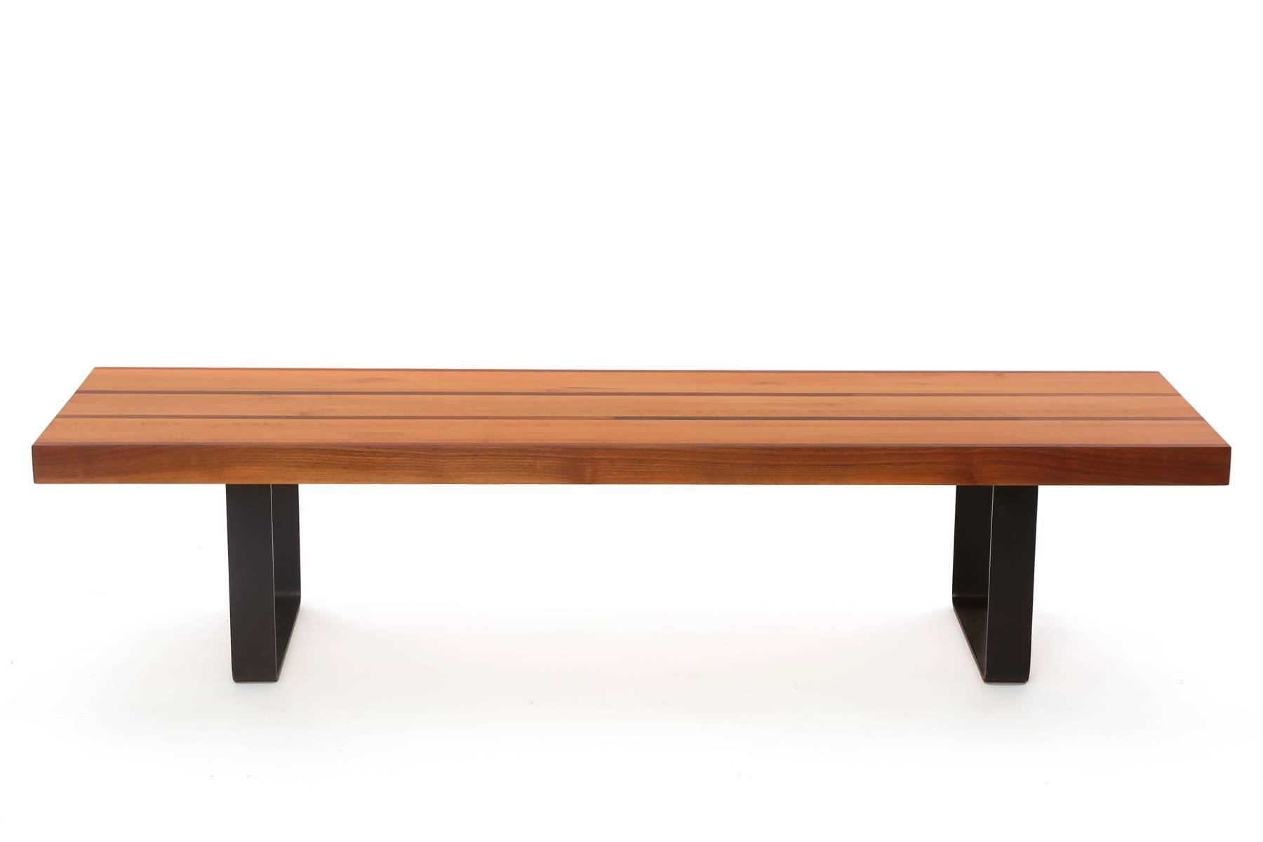 Custom 1950s walnut maple and iron bench or cocktail table, circa late 1950s. This unusual example has a solid maple top with inset walnut strips. The base is solid iron. The top has been recently impeccably refinished.