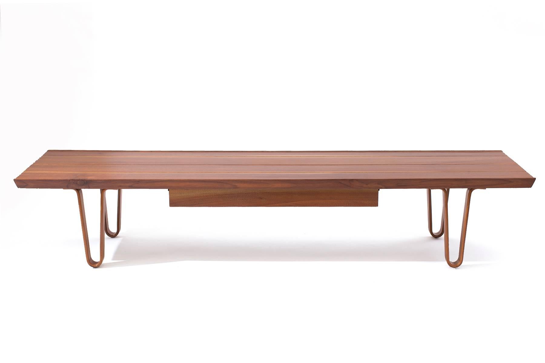 Edward Wormley for Dunbar long john bench with drawer, circa early 1950s. This example's top has solid walnut slats with beautiful sap grain. The legs are subtly curved laminated walnut. It has been recently impeccably refinished.