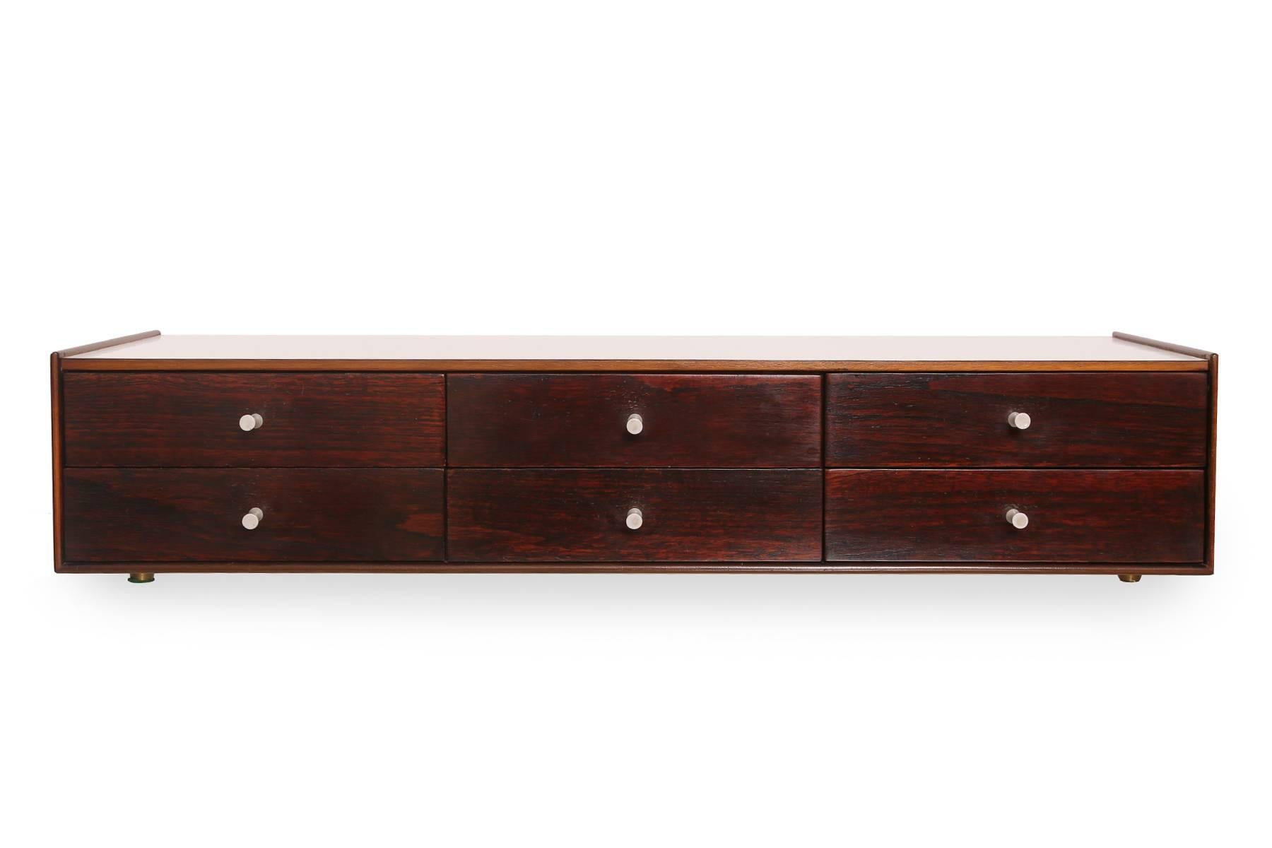 Rare and early George Nelson for Herman Miller jewelry chest, circa early 1950s. This seldom seen example has rosewood drawer fronts, walnut sides and white laminate top. The pulls are the the original porcelain. Retains foil label and drawer