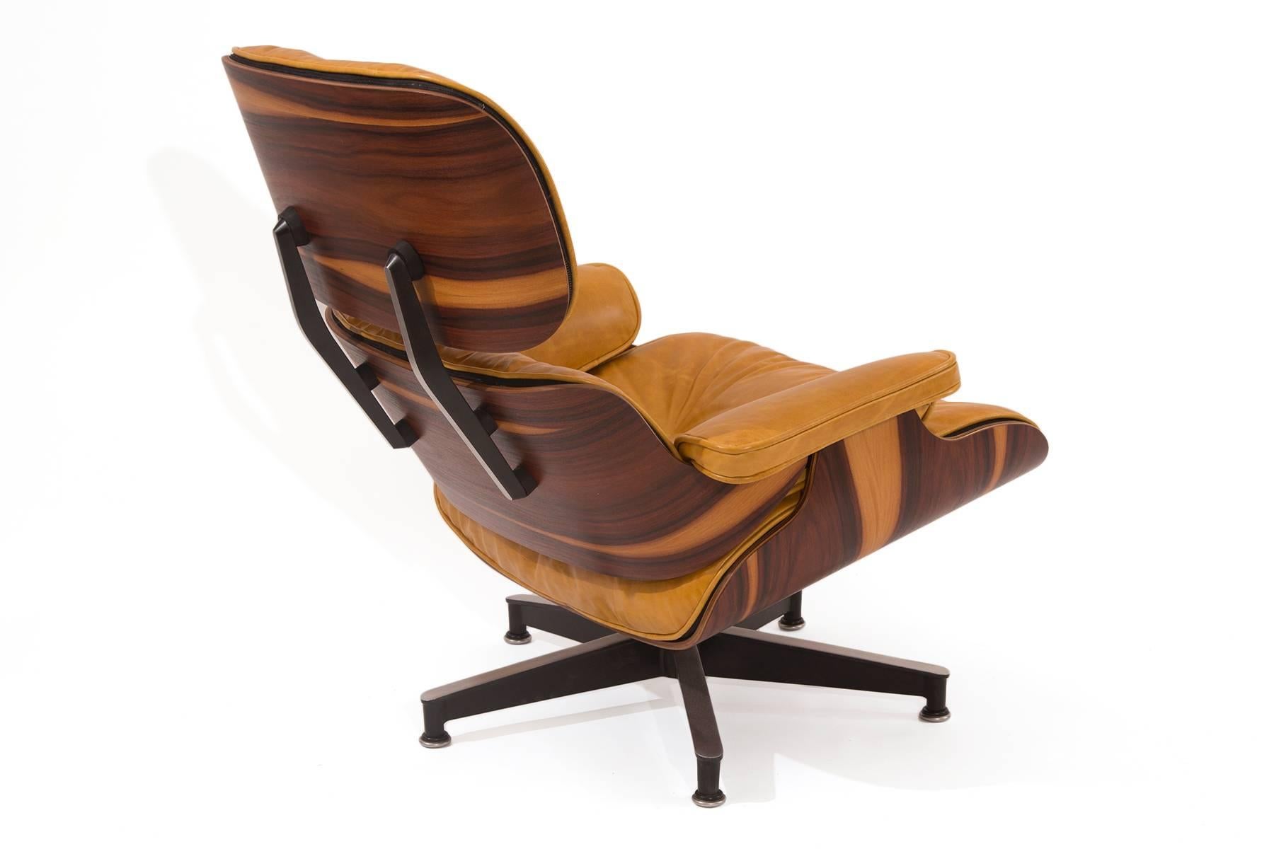 Charles and Ray Eames for Herman Miller 670 lounge chair and ottoman circa early 1970s. This example has incredible sap grain to the rosewood and has been upholstered in a perfectly patinated down filled butterscotch leather. Price listed is for the