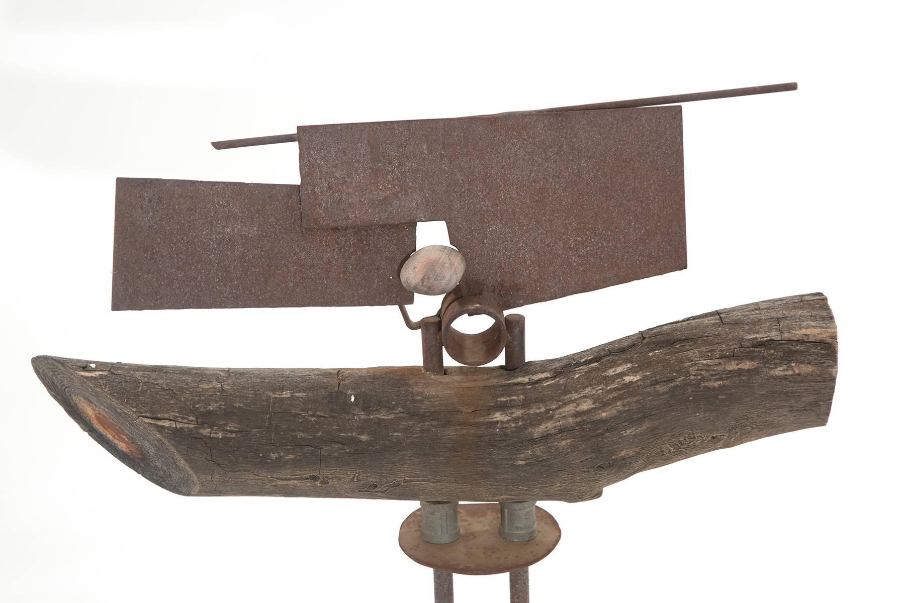 Wood, patinated steel and iron sculpture by Rick Lussier, circa early 1980s. This unusual example mixes different elements seamlessly and is striking from every angle.