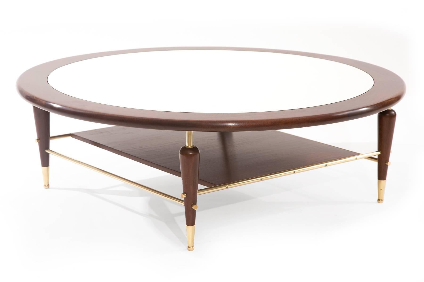 Fabulous walnut laminate and brass cocktail table, circa mid-1960s. This example has an inset white laminate top with solid walnut frame and legs. It has recently been impeccably refinished and the brass polished.