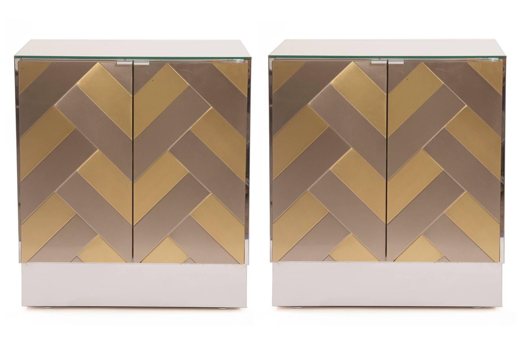 Pair of Ello mirrored nightstands, circa mid-1970s. These examples have brass and chrome Chevron doors with mirrored plinth bases sides and tops. Price listed is for the pair. Some patina to brass and chrome.