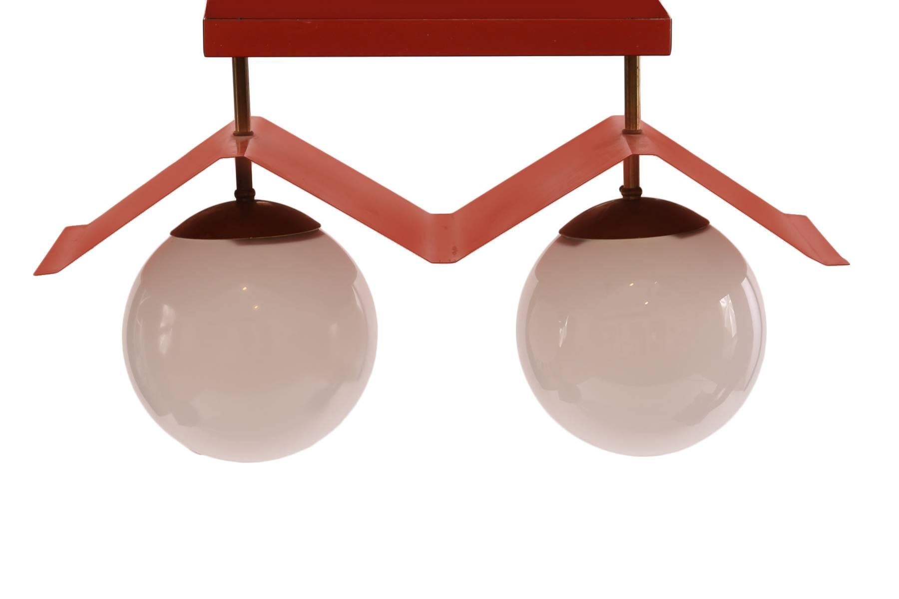 Enameled metal brass and glass Italian light fixture, circa early 1960s. This lovely example has its original enameled red canopy patinated brass and two glass globes.