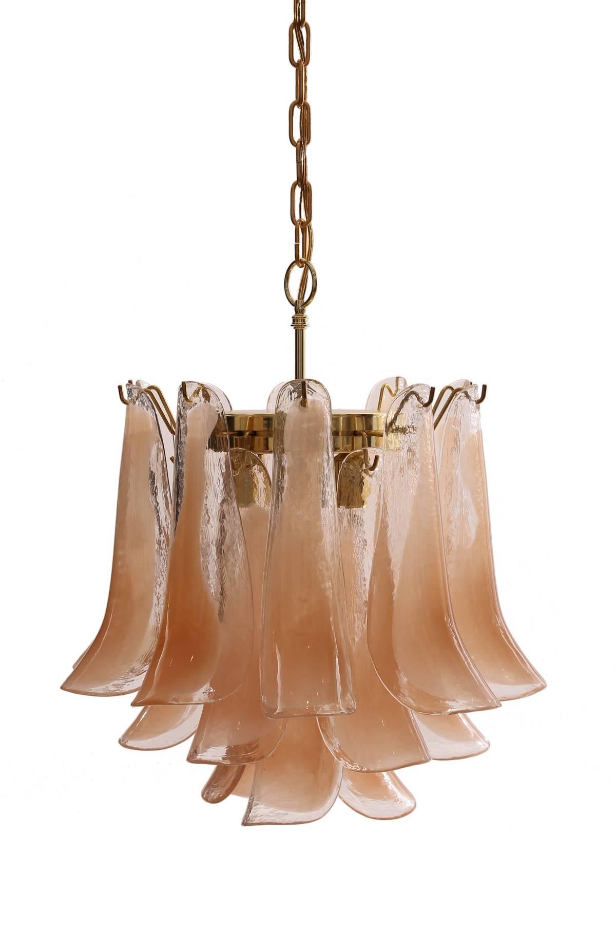 Murano glass chandelier by Mazzega, circa mid-1970s. This three-tiered example has semi opaque and flesh tone Murano glass petals.