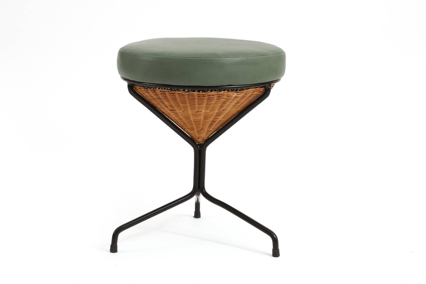 Danny Ho Fong for Tropi-Cal stools circa late 1950s. These examples have recently powder coated tripod iron legs with inset woven wicker forms and newly upholstered green leather seats. Price listed is for the pair.
