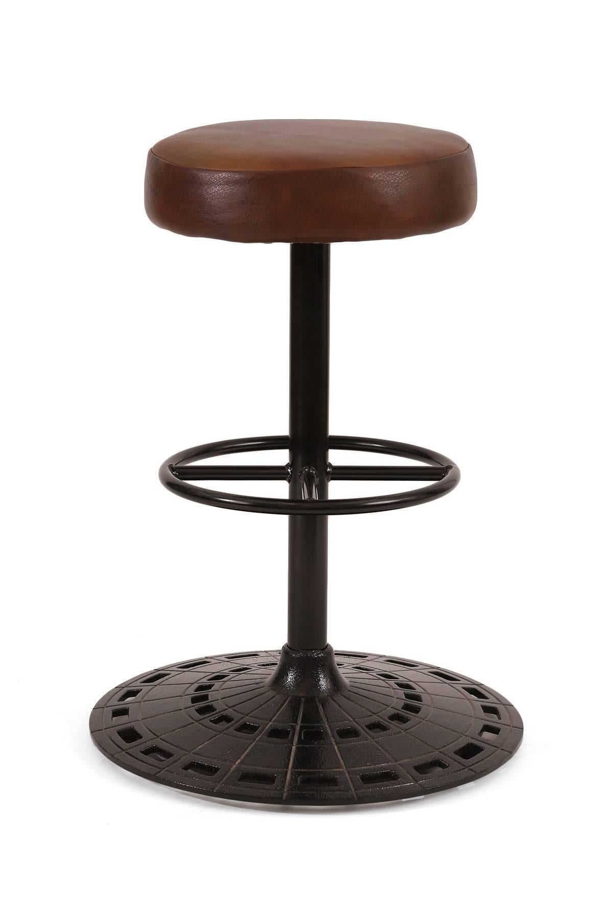 Six leather and cast iron swivel bar stools circa mid-1970s. These examples have perforated stout iron bases that have been newly powder coated. The seats are upholstered in a buttery tobacco leather. These can be sold individually or as a set.