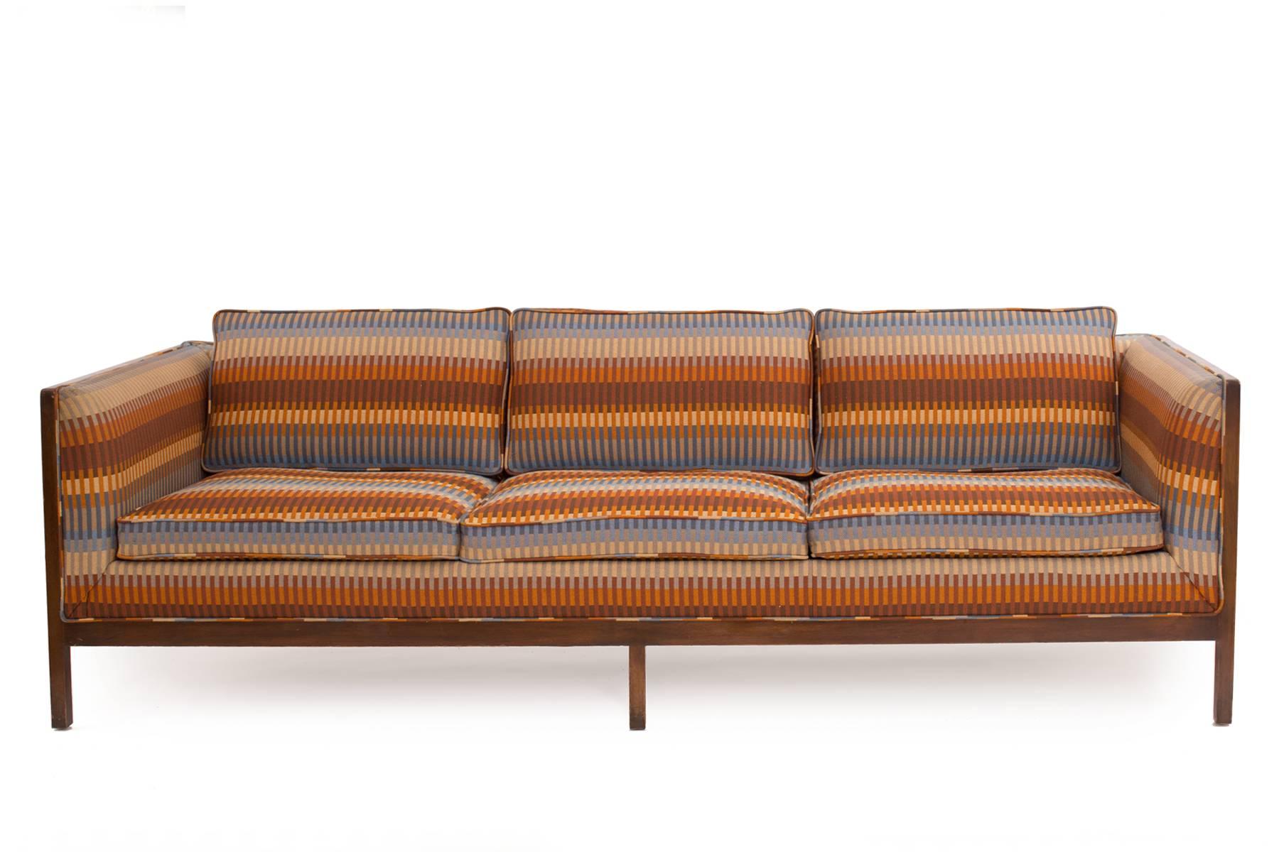 Fabulous sofa by Stow Davis, circa early 1960s. This example has a solid walnut frame with incredible all original upholstery.
Interiors of all cushions have been replaced. Back cushions are a down mix and the seat cushions comfortable HR foam.