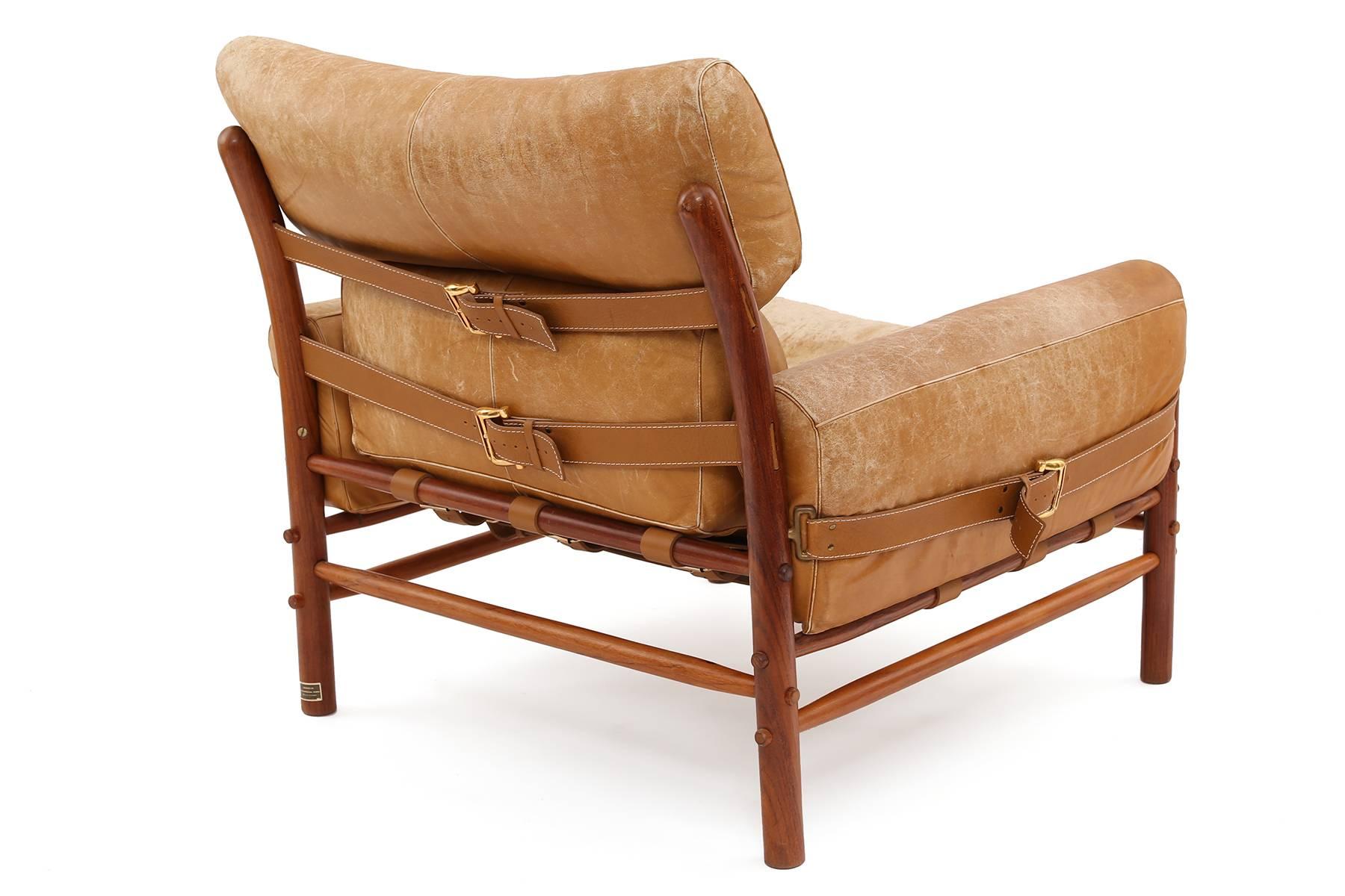 Beech leather and brass lounge chair by Arne Norell, circa mid-1960s. This all original example has perfectly patinated camel leather with brass buckle detailing and solid beechwood frame. Retains original designer label.


