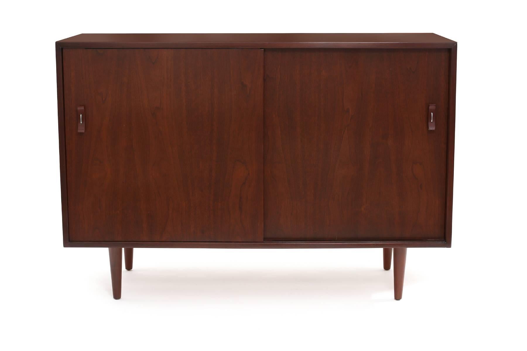 Stanley Young for Glenn of California walnut chest, circa late 1950s. This lovely example has been recently impeccably refinished. It has Glenn's iconic bentwood handles and burnt orange lacquered interior drawer fronts.