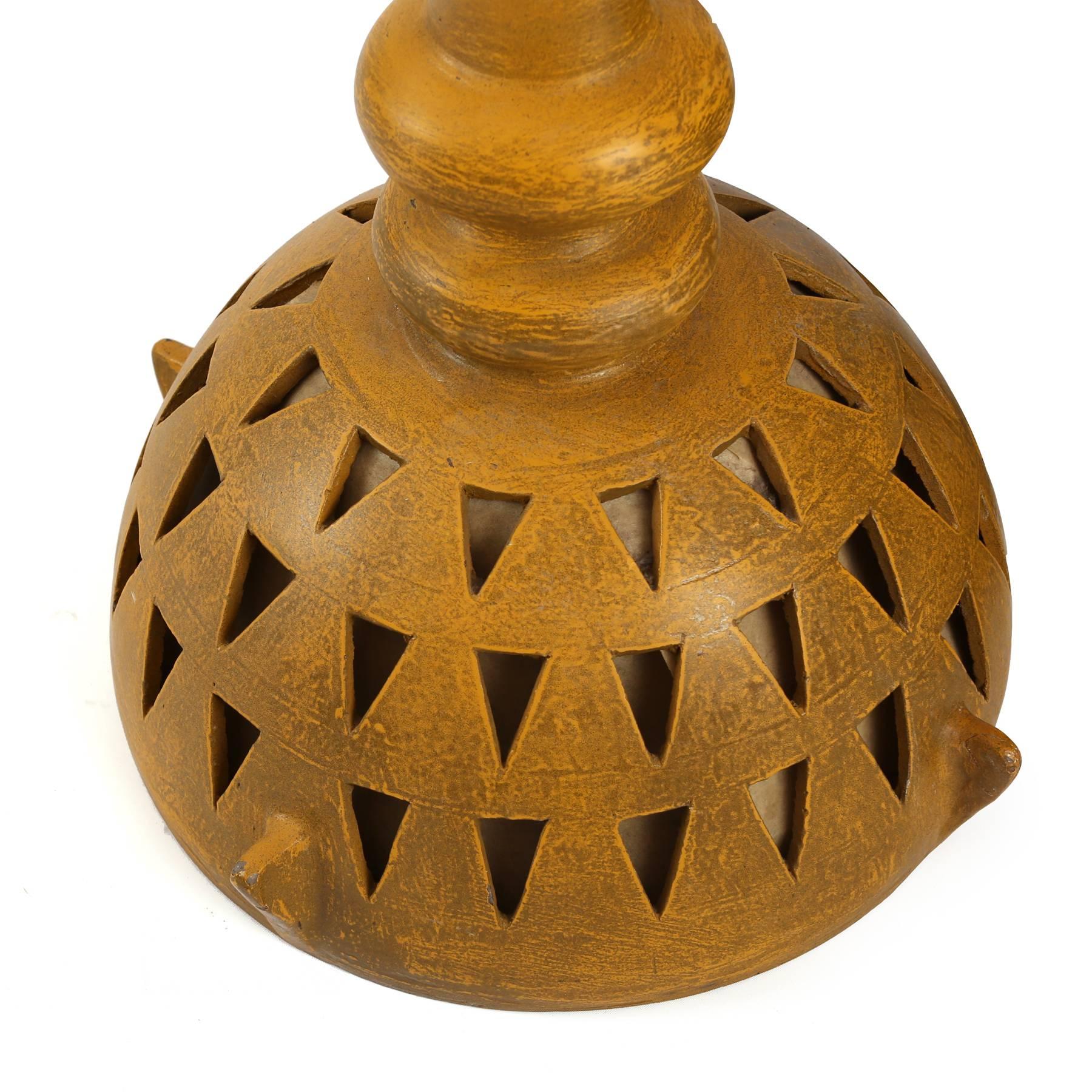 Studio ceramic hanging light, circa early 1960s. This example has beautiful earth tones mixed with an architectural form and triangular and circular cutouts.