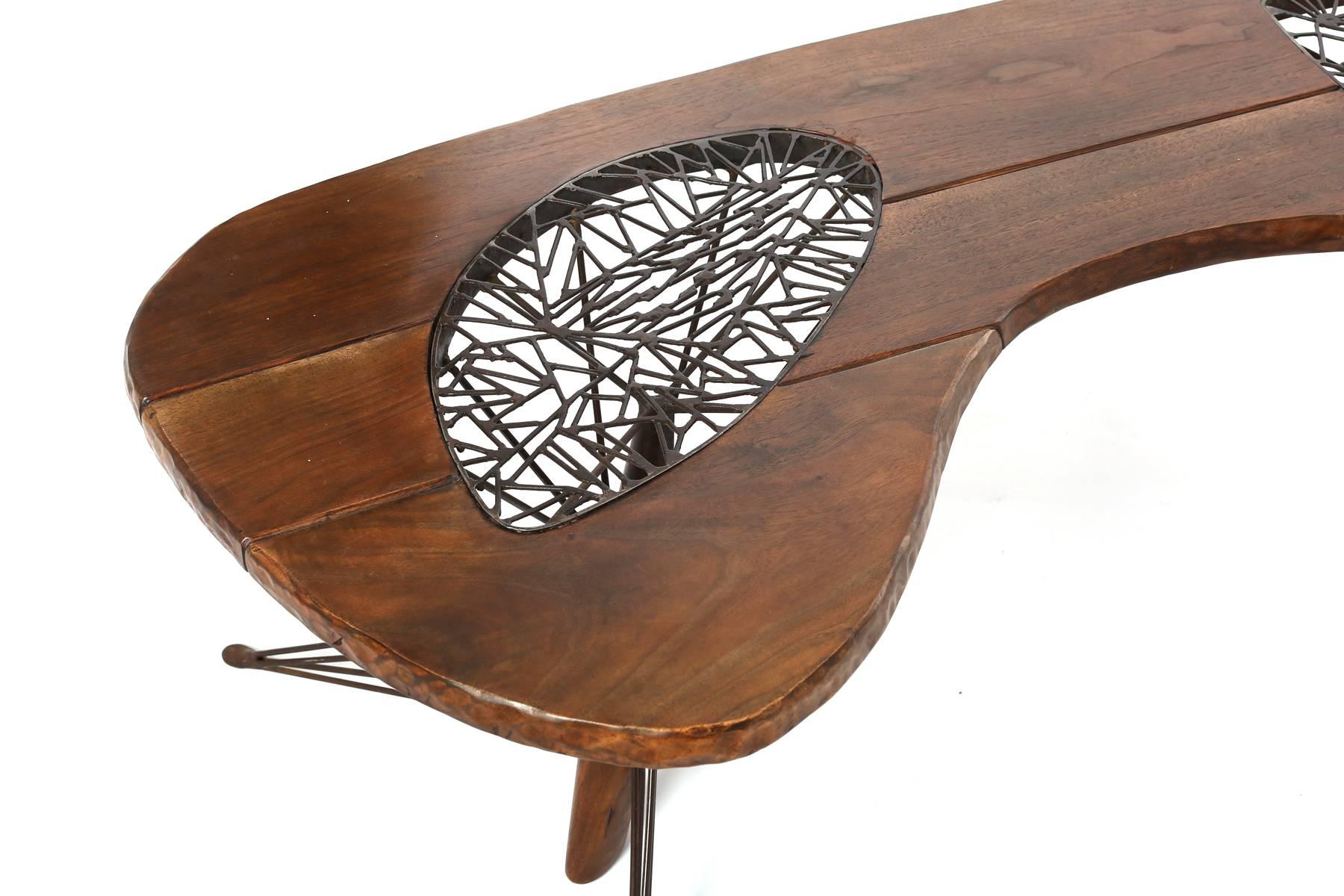 One off cocktail table by Allen Ditson, circa mid-1950s. This extraordinary example seamlessly mess solid walnut with patinated steel. Please see our other examples for other works by Ditson.