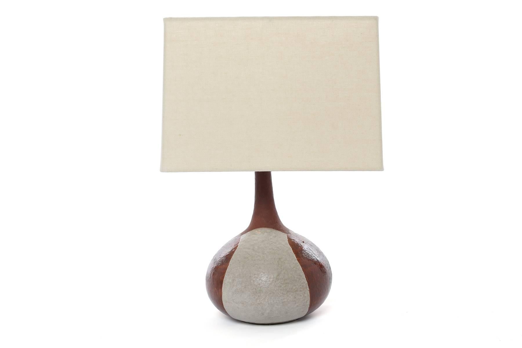 Pair of David Cressey glazed ceramic table lamps, circa early 1960s. These examples use Cressey's iconic earth tone glazing and are priced as a pair without the shades. Shades can be procured by Red. Please inquire. Dimensions below are to the top