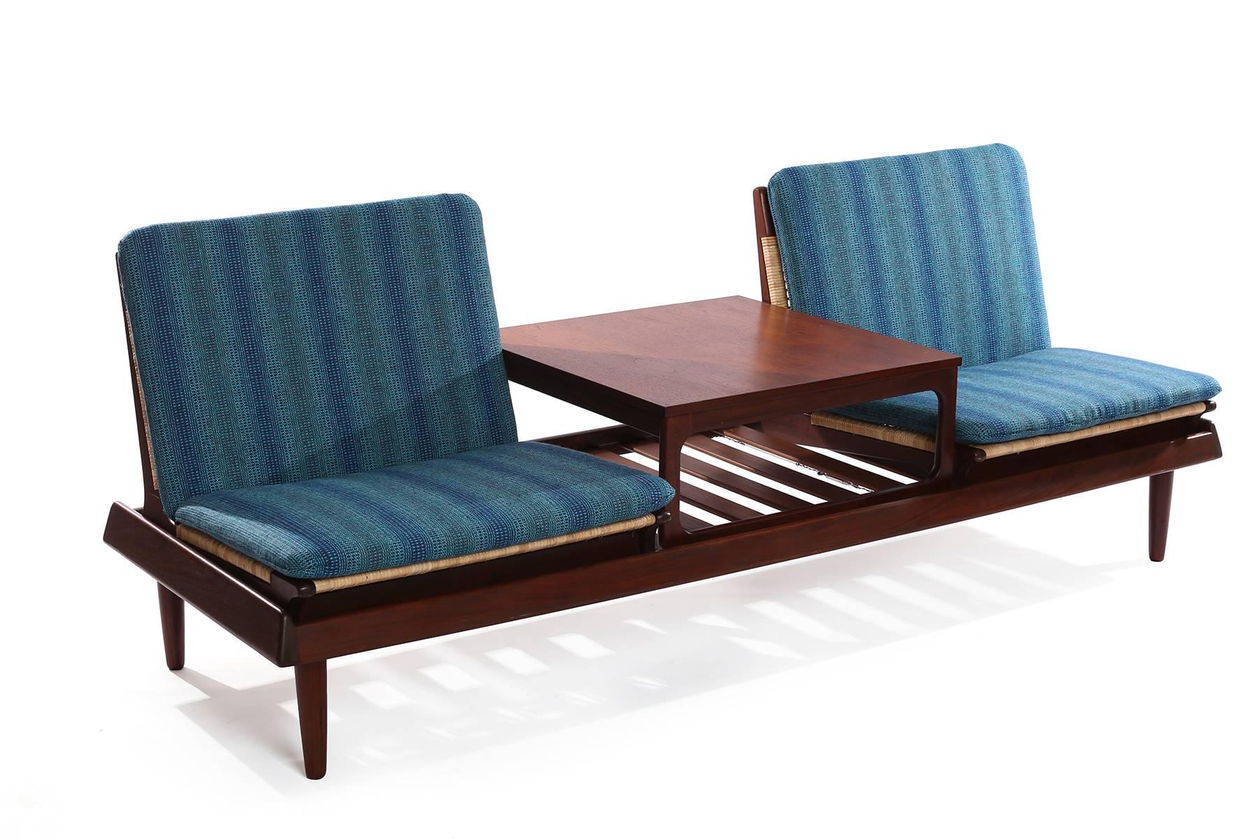 Seldom seen Hans Olsen modular seating, circa late 1950s. This versatile and stunning example has two low chairs and table that sit atop a bench.
The chairs and table are movable and removable so that they can sit in different configurations atop