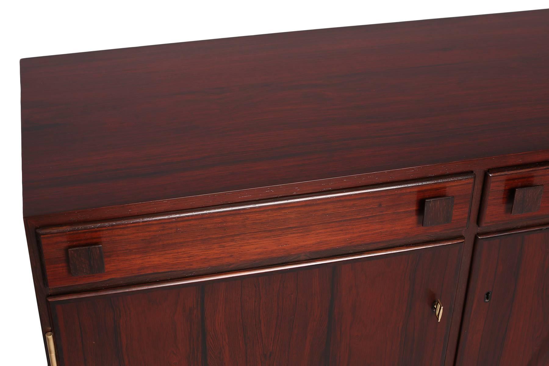 Takashi Okamura & Erik Marqurdsen rosewood chest, circa late 1950s. This elegant example has a beautifully grained rosewood case, two drawers and adjustable interior shelves. It has been newly refinished.