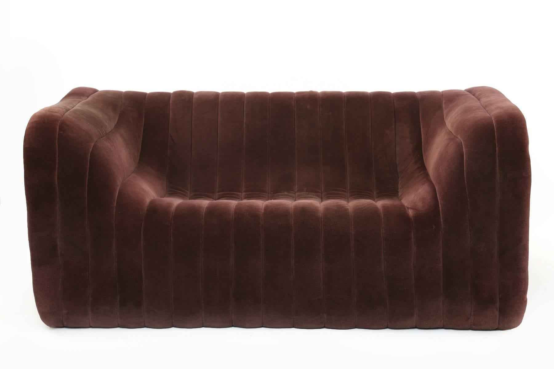 Wonderful pair of Artima for Turner Ltd. velvet love seats from Switzerland, circa early 1970s. These all original examples retain their original eggplant velvet upholstery and have lovely hand-sewn channeling over sculpted foam. Price listed is for