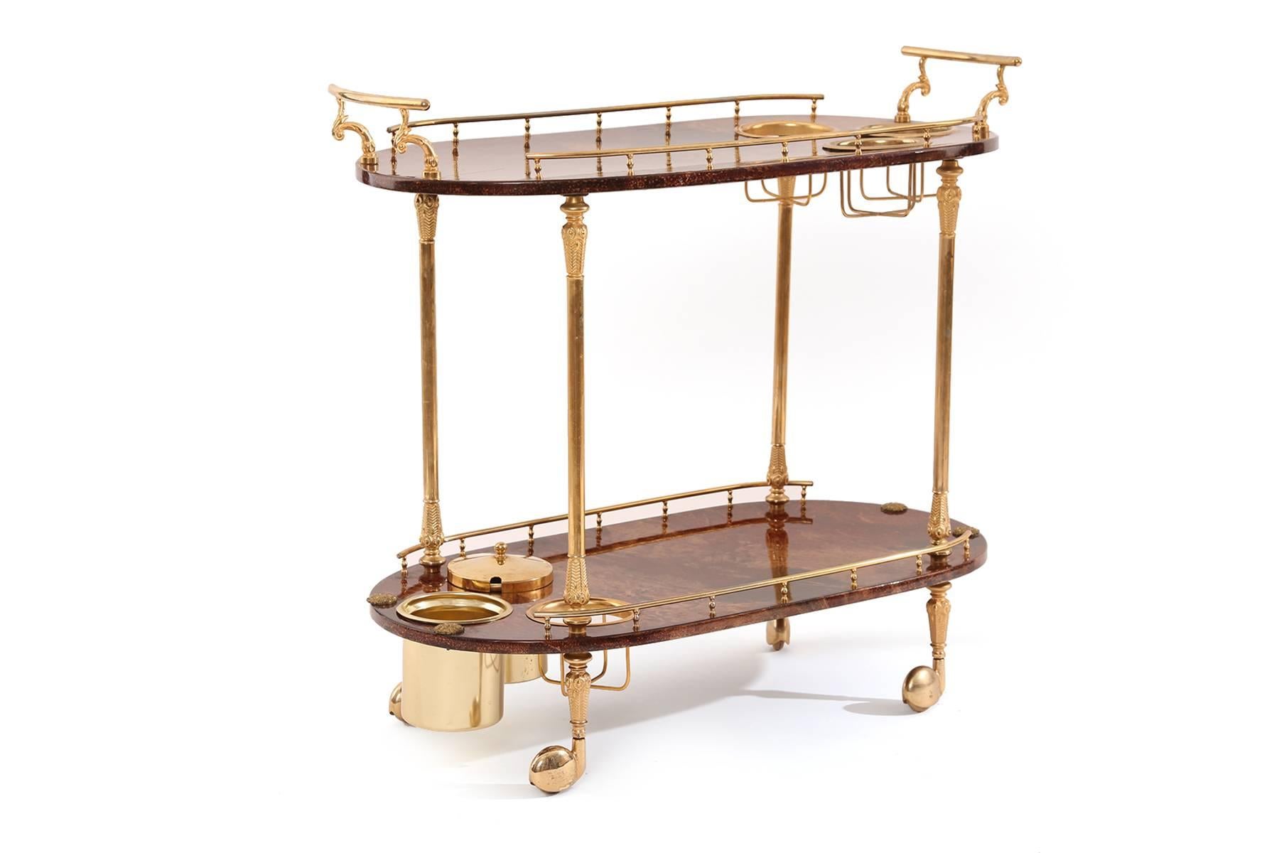 Pair of lacquered goatskin and brass bar carts by Aldo Tura, circa late 1950s. One of these examples has removable storage pieces and areas for bottles. Both have patinated brass detailing chocolate brown lacquer sealed goatskin surfaces and brass