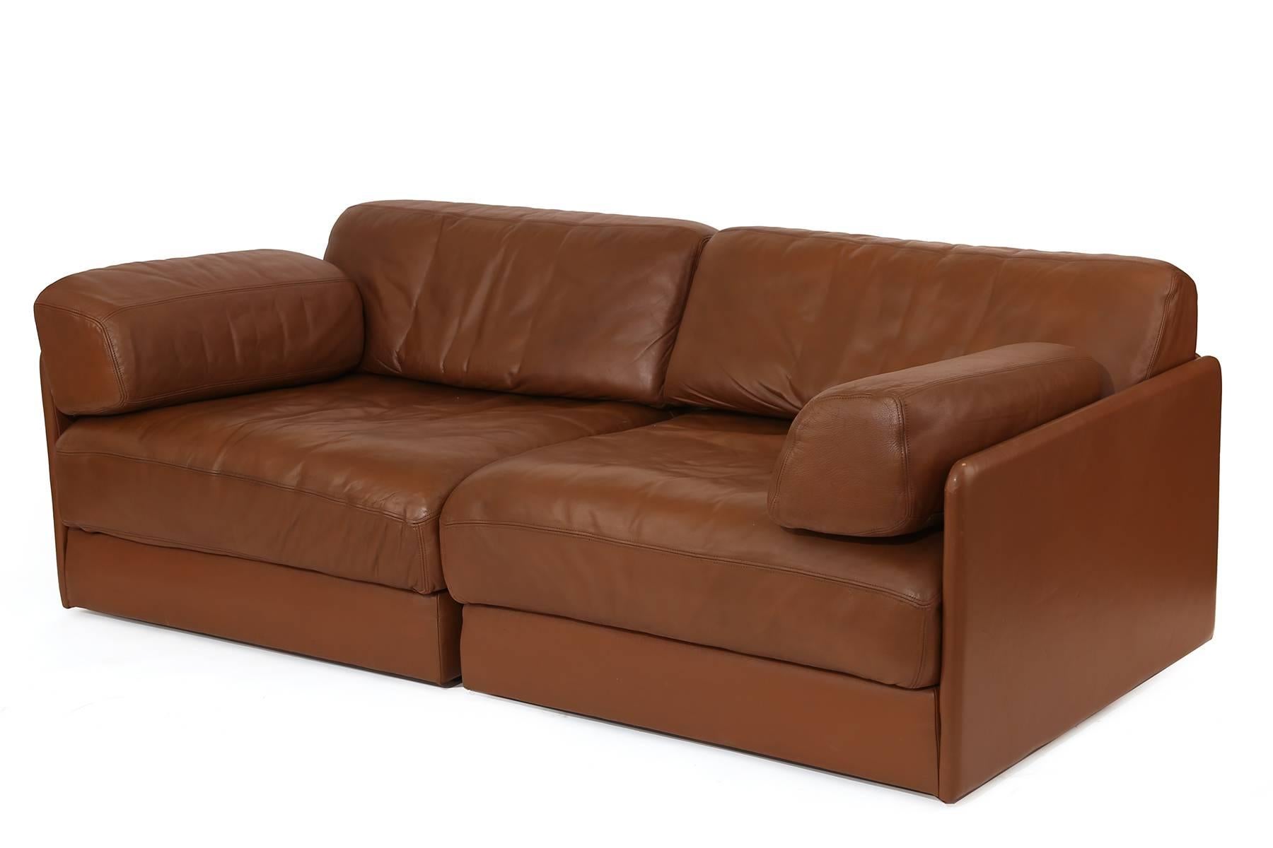 De Sede leather chairs or sofa, circa mid-1970s. These examples are done in their original supple milk chocolate leather and can be used as individual chairs or as a smaller sofa.
Cushions are removable to create a large sleeping area.
 