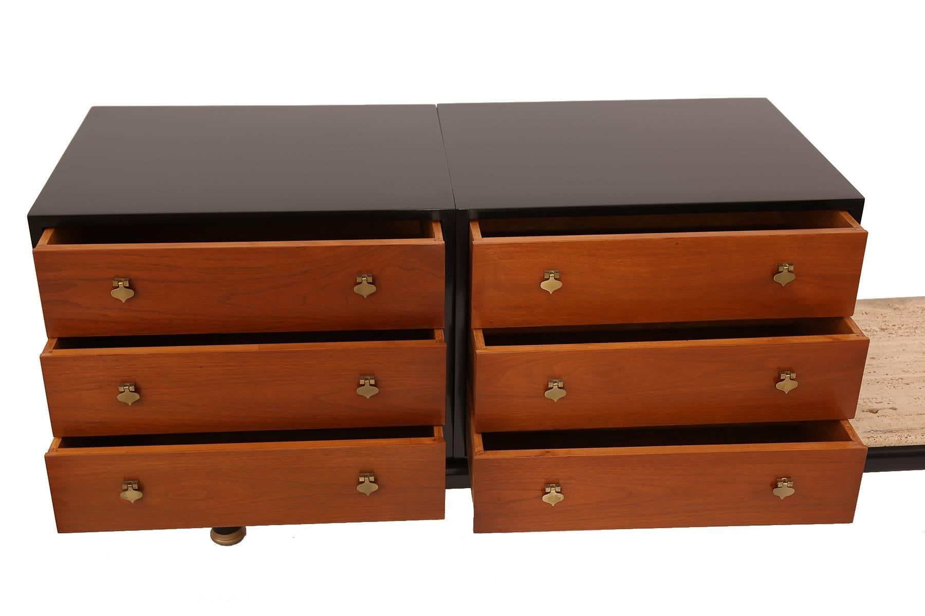 Renzo Rutili for Johnson Furniture Company chest of drawers on a bench platform, circa early 1960s. This stunning example has an ebonized frame, inset travertine table top and six mahogany drawers with patinated brass shamrock hardware.