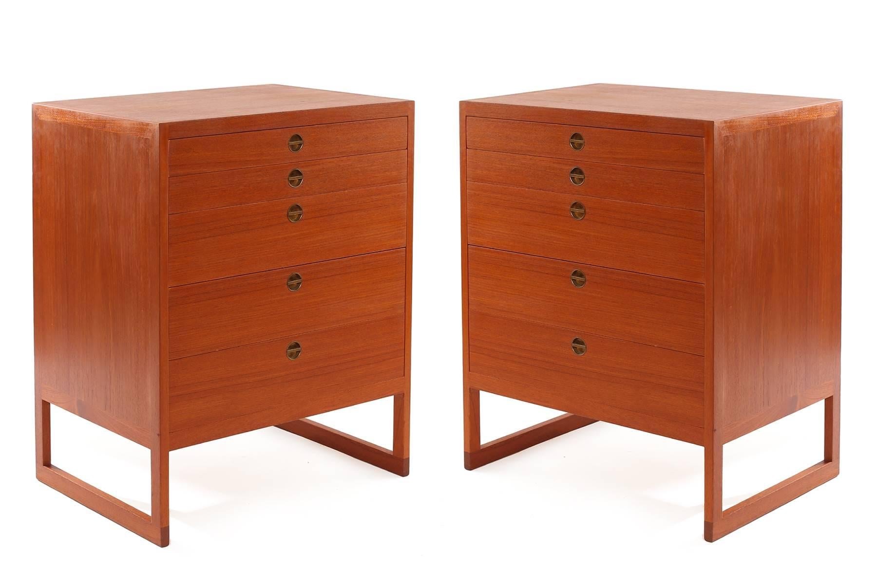 Pair of teak and brass chests by Borge Mogensen circa late 1950s. These all original examples are solid teak with inset patinated brass handles and five drawers each. Perfect as large-scale night stands or as smaller scale dressers. Price listed is