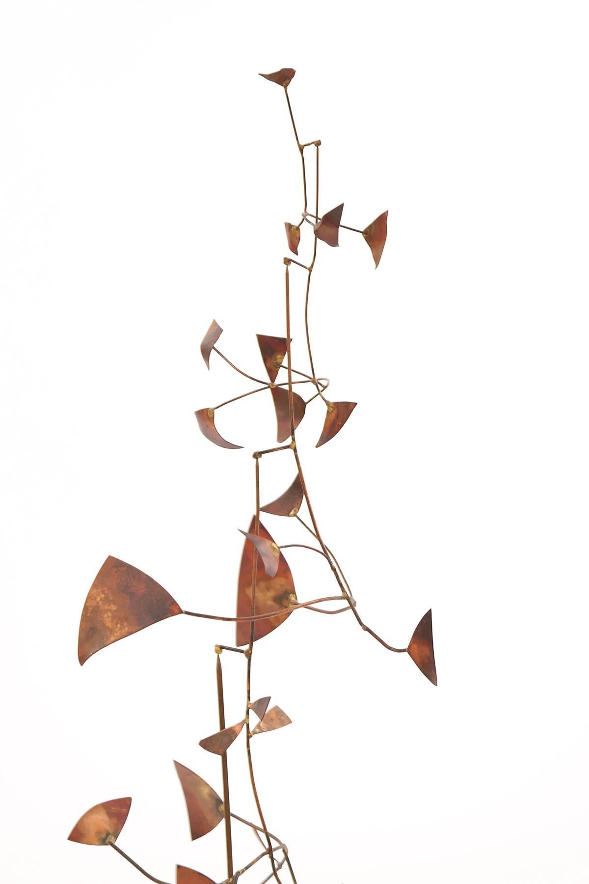 Patinated copper stabile, circa early 1970s. This all original example has several arms with free-form attachments. The arms all move creating a beautiful Kinetic sculpture. Unknown artist.