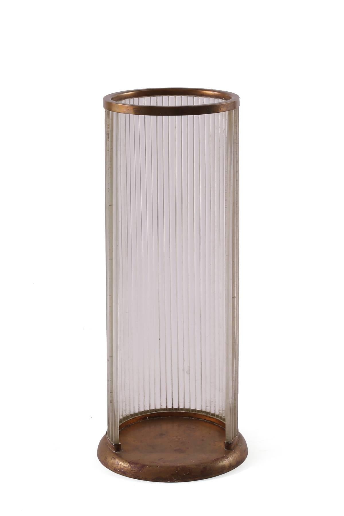 Lucite and bronze finished metal umbrella stand from Italy, circa early 1970s. This example reminiscent of the works of Gabriella Crespi has a beautifully patinated base and top that are connected by tubular rods of Lucite.