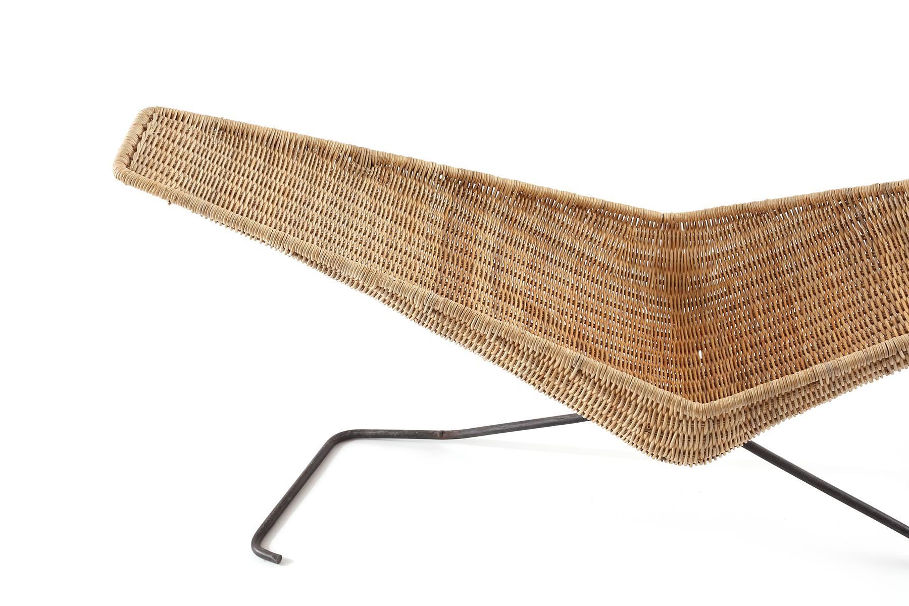Fabulous wicker and iron magazine holder or catch all from Italy, circa late 1950s. This all original example has a V-shaped wicker top perfect for storage of books or magazines that sits atop a patinated iron base.