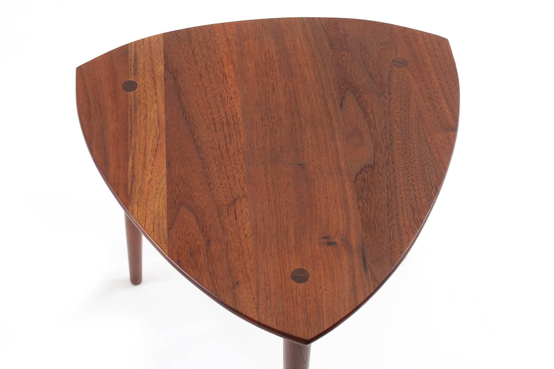 Pair of Kipp Stewart for Winchendon solid walnut side tables, circa early 1960s. These sculptural examples have beautifully grained triangular tops with tapered legs and stretchers. Price listed is for the pair.