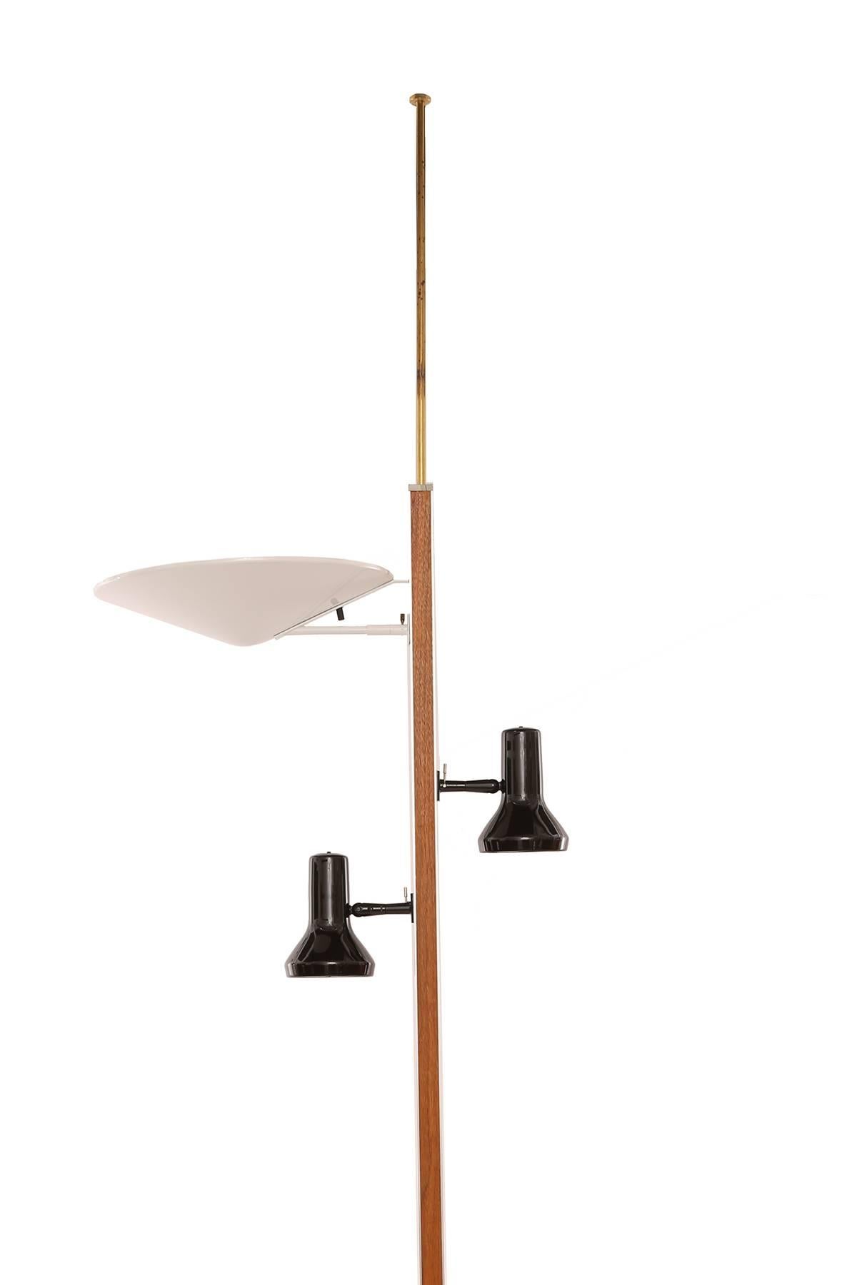Gerald Thurston for Lightolier Pole lamp, circa early 1960s. This example has a walnut and anodized aluminium pole, white enameled dome light and two black enameled spots. It has been newly finished and wired. Extends from 79