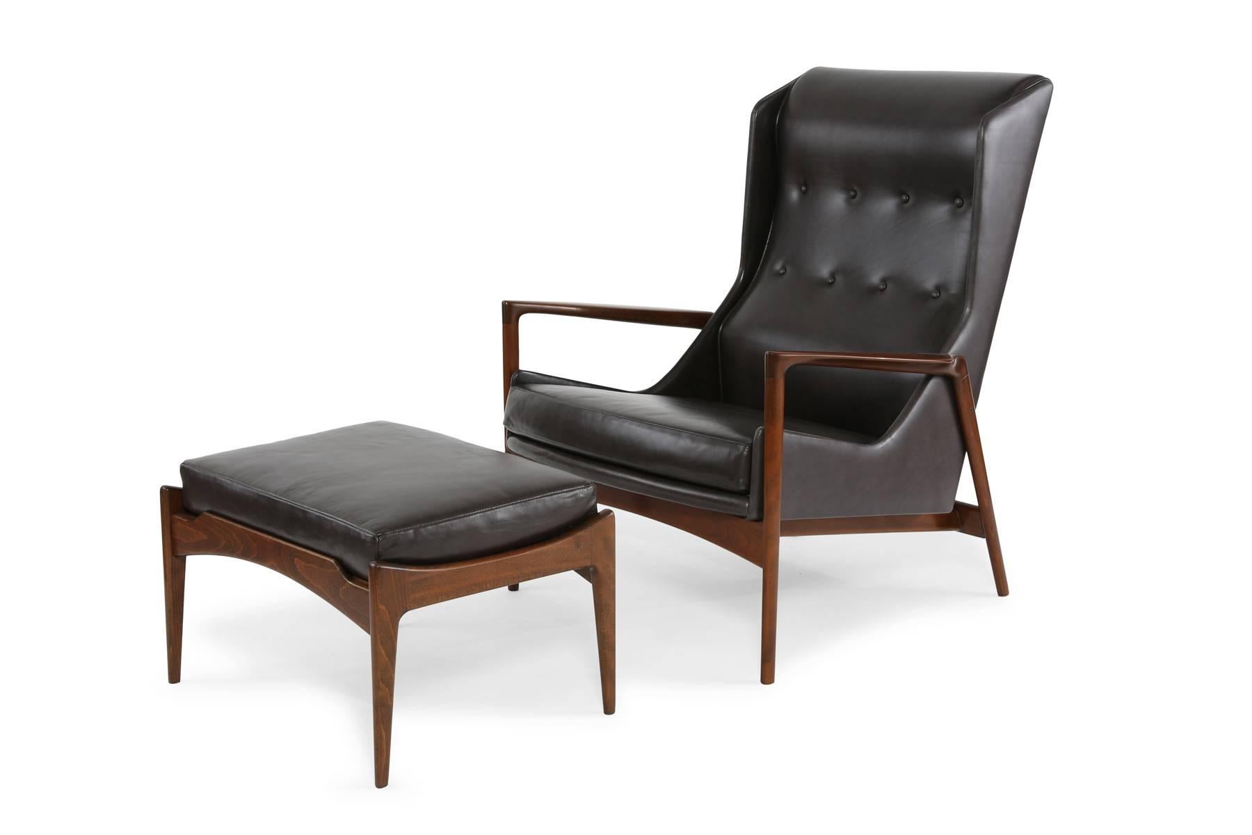 Seldom seen pair of lounge chairs and ottoman by Ib Kofod Larsen. These stunning examples have sculpted newly finished solid teak frames and have been masterfully upholstered in a perfectly patinated charcoal leather. Price listed is for the pair of
