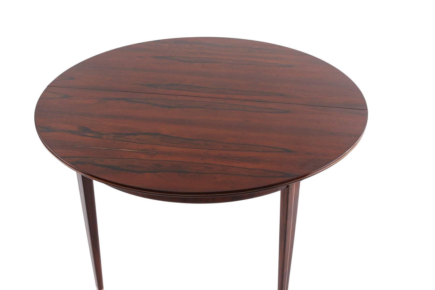 Rare rosewood and pewter dining table by Georg Kofoed, circa late 1930s. This incredible example has a beautifully grained rosewood top and extends from 49