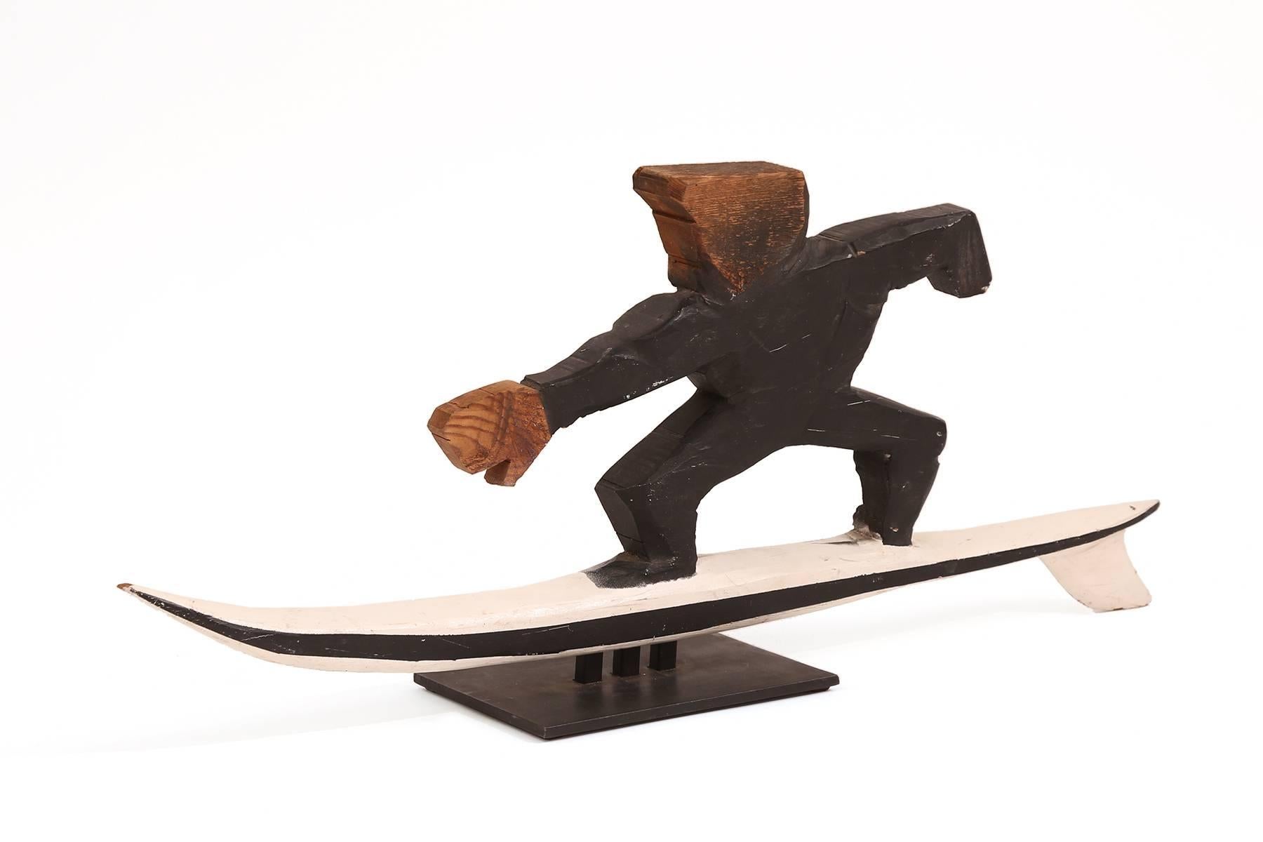 Folk Art surfer sculpture, circa early 1950s. This unsigned example has wonderful movement and patina and is a perfect gift for your favorite surfer friend.