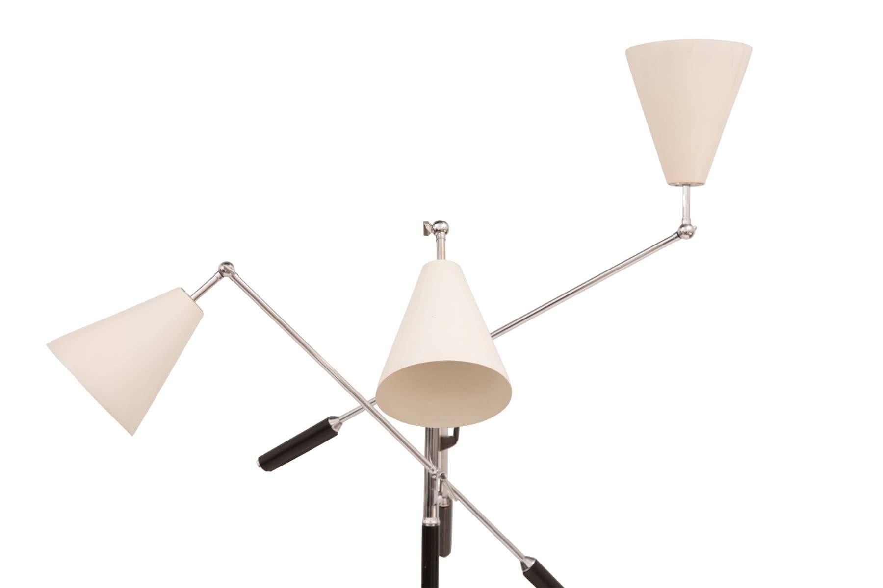 Arredoluce three-arm floor lamp, circa late 1960s. This example has a Carrara marble base chrome stem and arms with patinated hand sewn leather handles. The cream cones retain their original finish and the lamp is stamped made in Italy on the top of