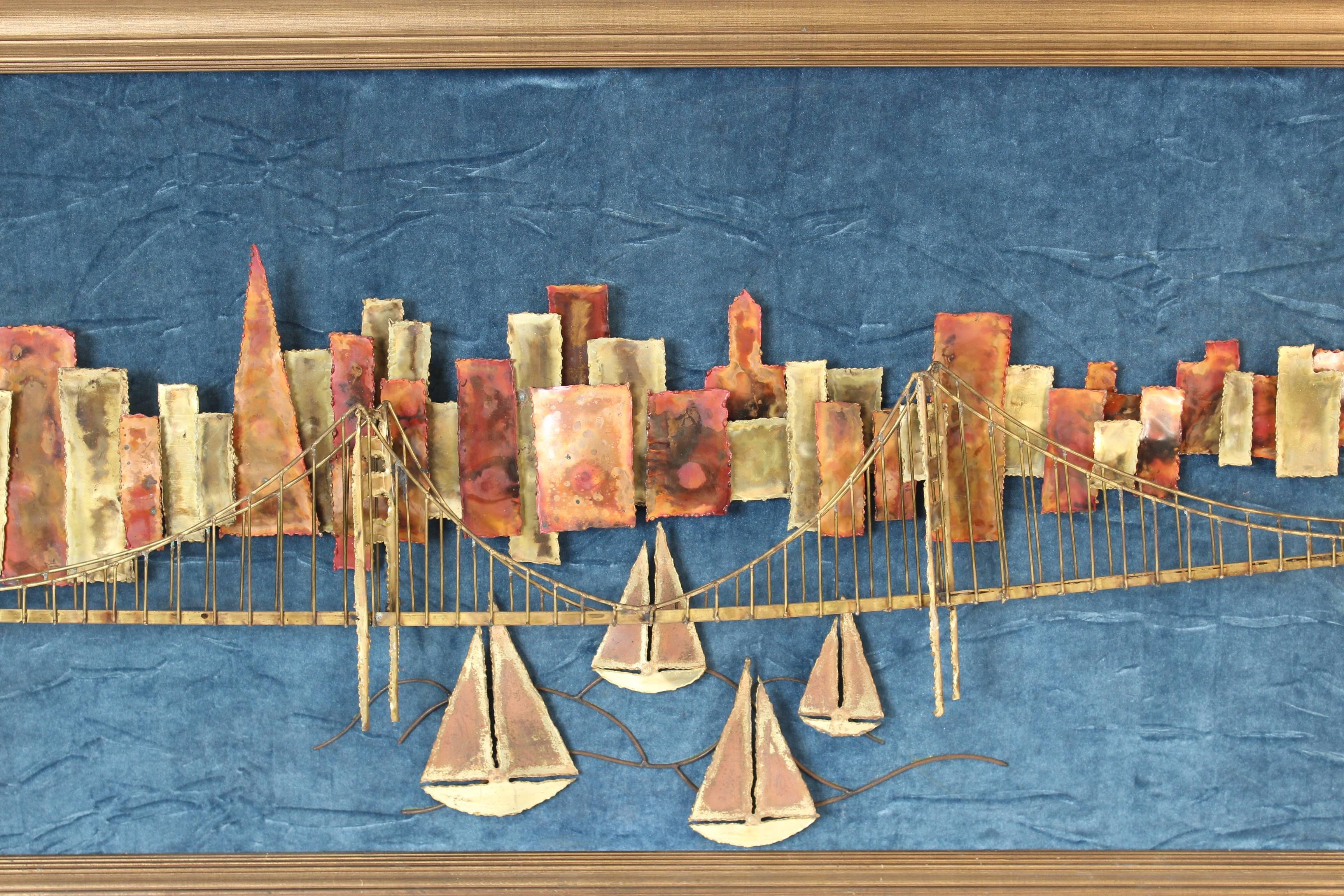 Mixed metal wall sculpture of the San Francisco skyline, Golden Gate bridge and sailboats, on a velvet background, circa 1980s.