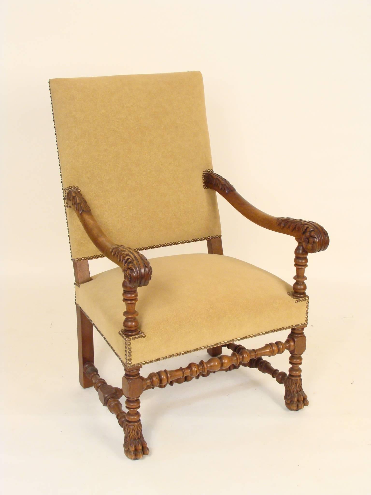 Pair of Baroque style carved walnut armchairs, circa 1900. These chairs have excellent carved walnut arms and feet. The upholstery is new and in excellent condition.