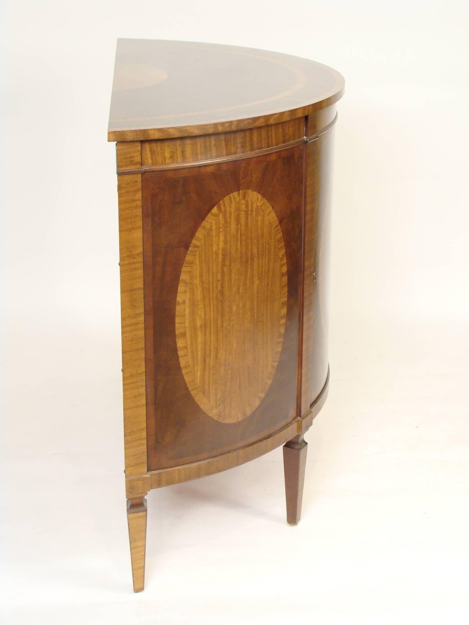 Barbara Barry for Baker English neoclassical style mahogany demilune cabinet with satinwood inlay, circa 1990.