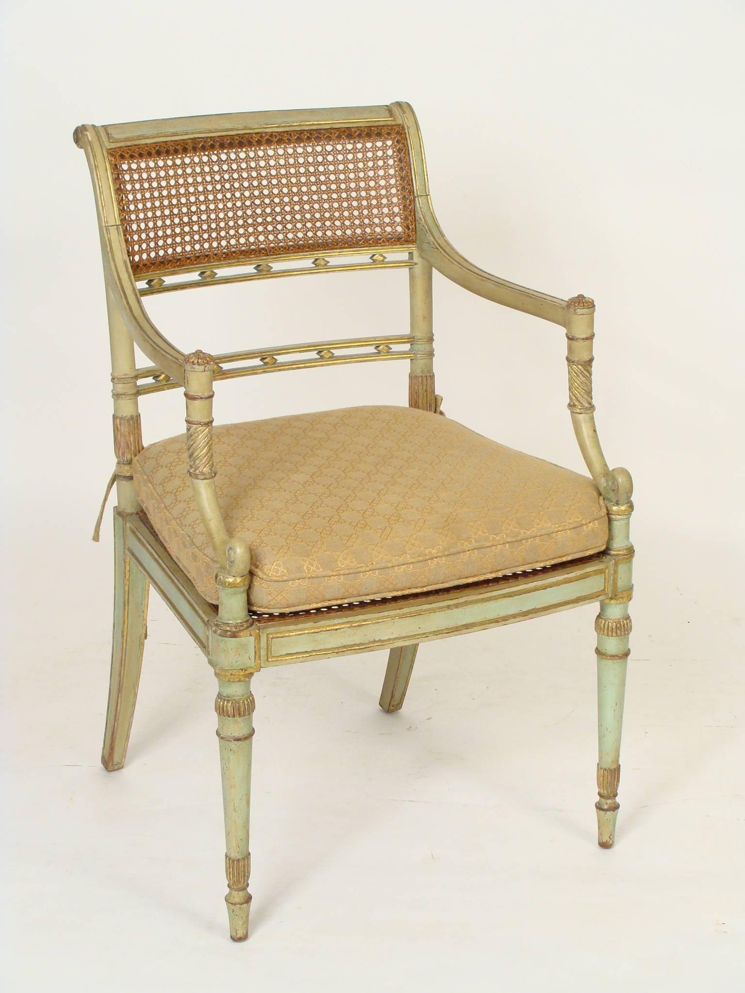Pair of painted and partial-gilt English Regency style armchairs with caned backs and seats, circa 1990.