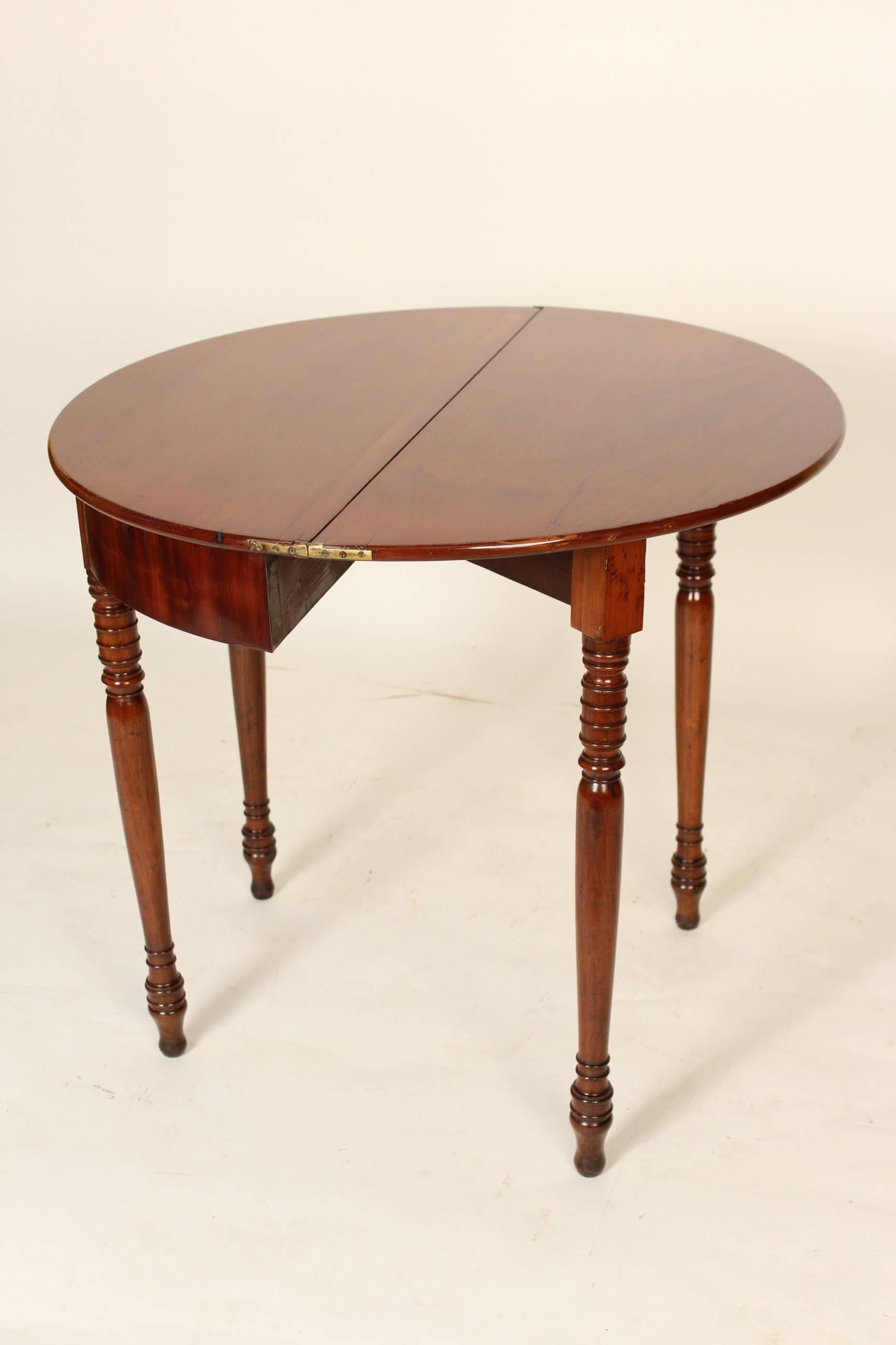 Charles X mahogany Demilune games table, circa 1830. The diameter when the top is opened is 33.5