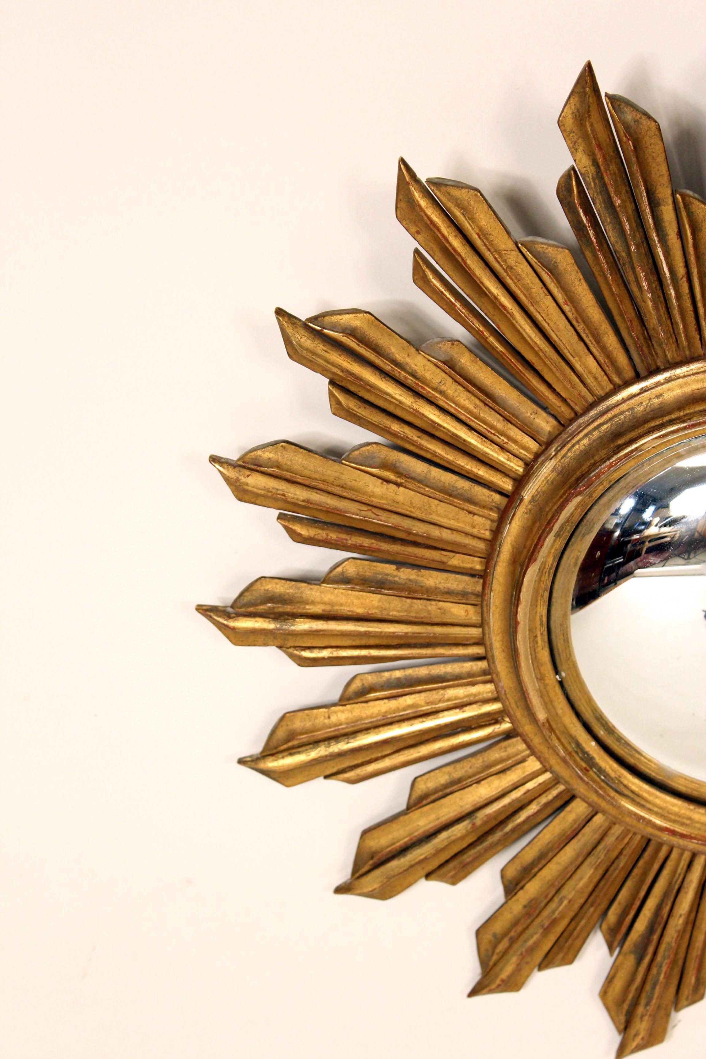 Continental giltwood starburst mirror with a convex glass mirror, mid-20th century.