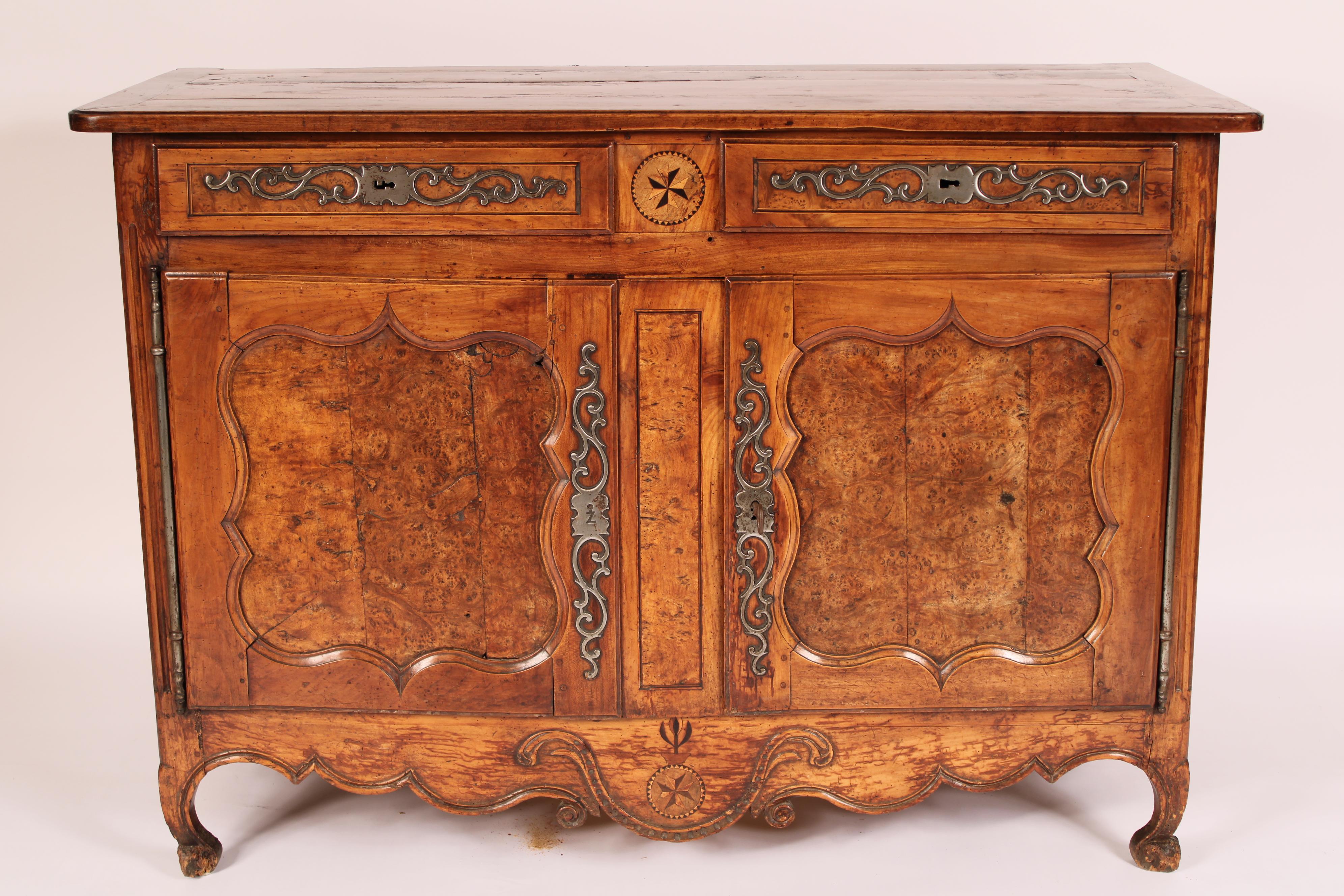 Louis XV provincial fruitwood, elm, burled elm and beech wood buffet, 18th century. With a rectangular 4 board top with molded edges and rounded front corners, two frieze drawers each with horizontal steel escutcheons, below are two doors each with