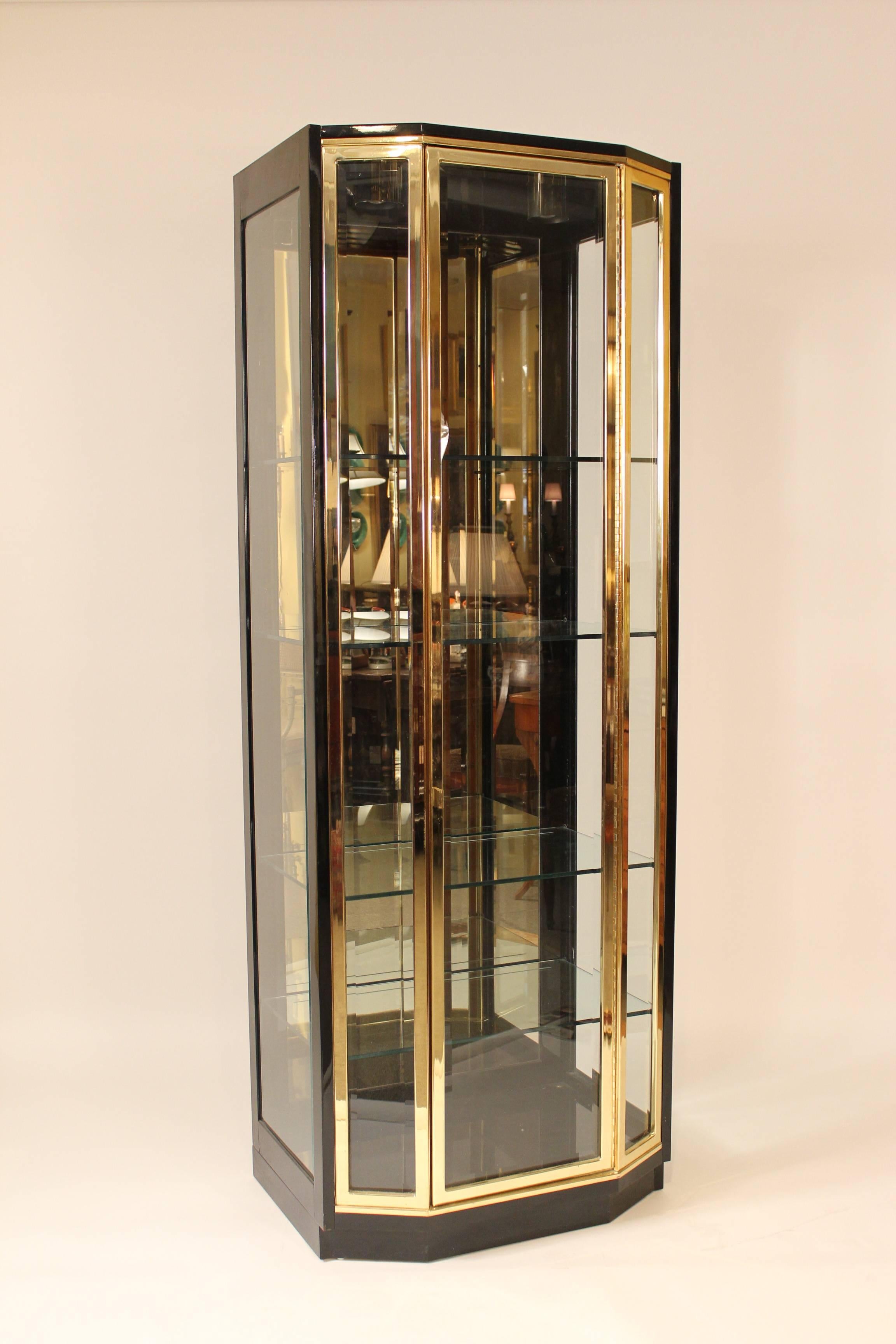 Pair of Henredon Mid-Century Modern style, black lacquer, brass and glass display cabinets with interior lights, circa 1990.