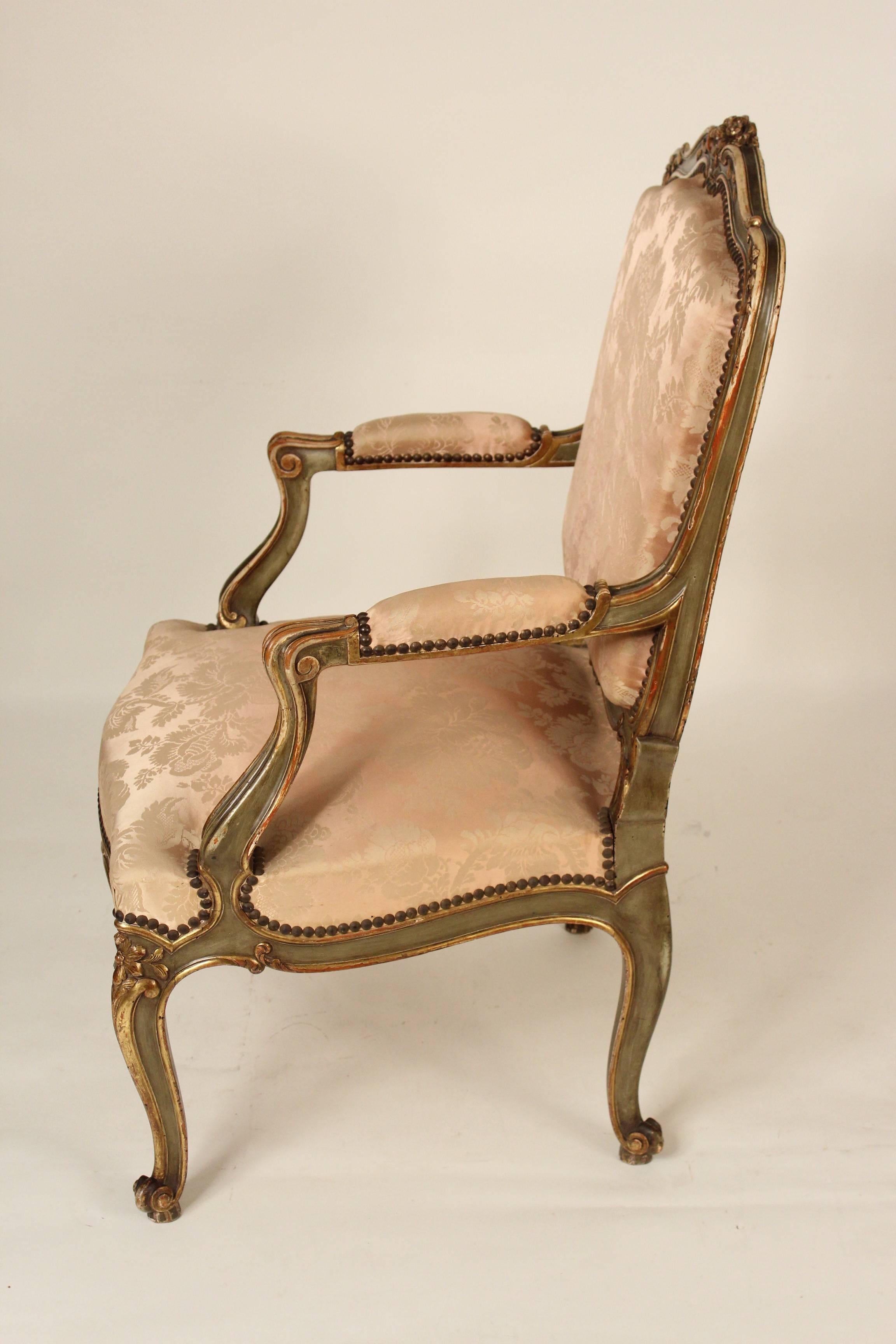 Louis XV style painted and partial gilt armchair, circa 1910. This chair has a very nice quality original gold leaf and painted finish. Very minor old inactive worming.