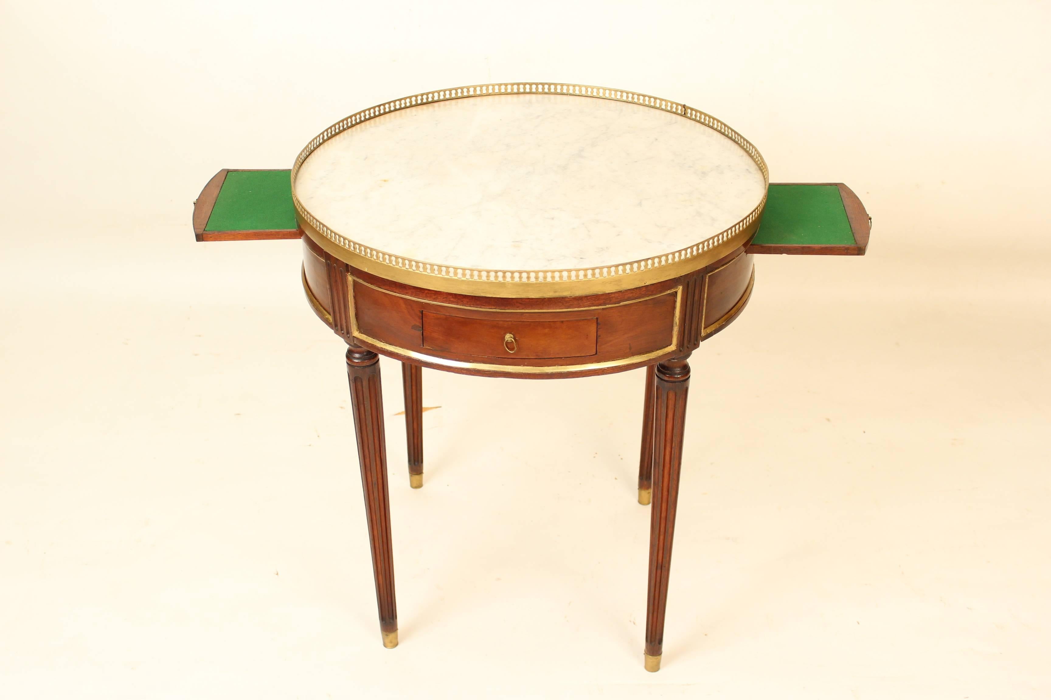 Louis XVI style mahogany bouillotte table with brass mounts and a marble top, circa 1930. Height to top of brass gallery 27