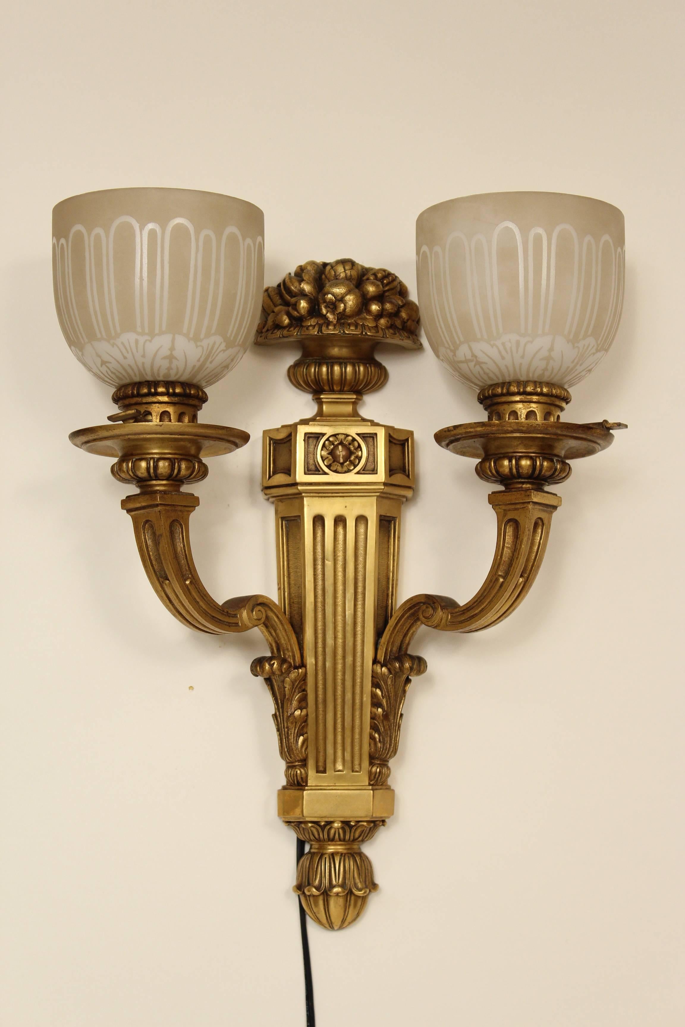 Pair of Louis XIV style gilt bronze two-light wall sconces with acid etched glass shades, circa 1920.
