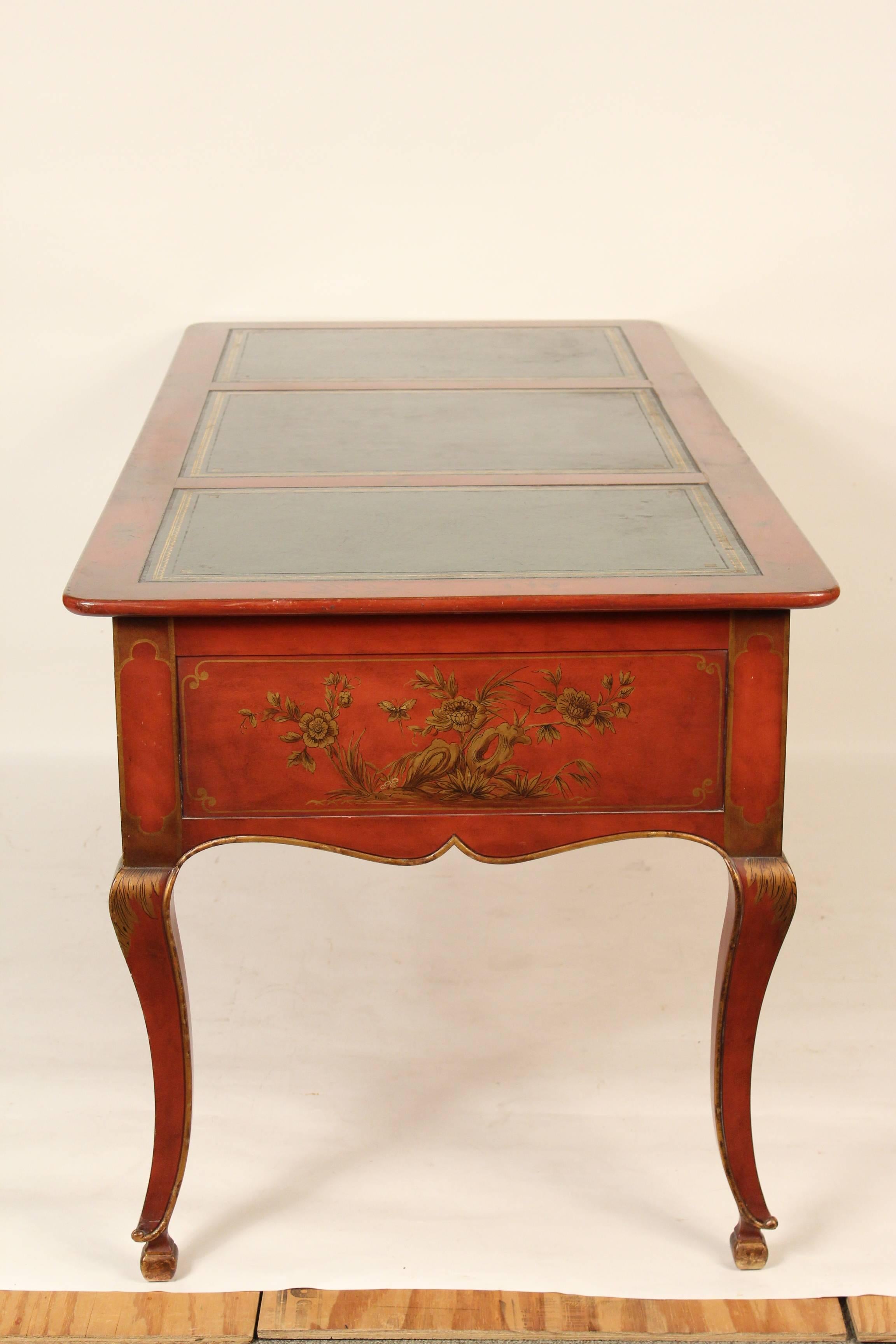 Louis XV style red chinoiserie decorated desk with a green tooled leather top, made by Baker, circa 1970s.