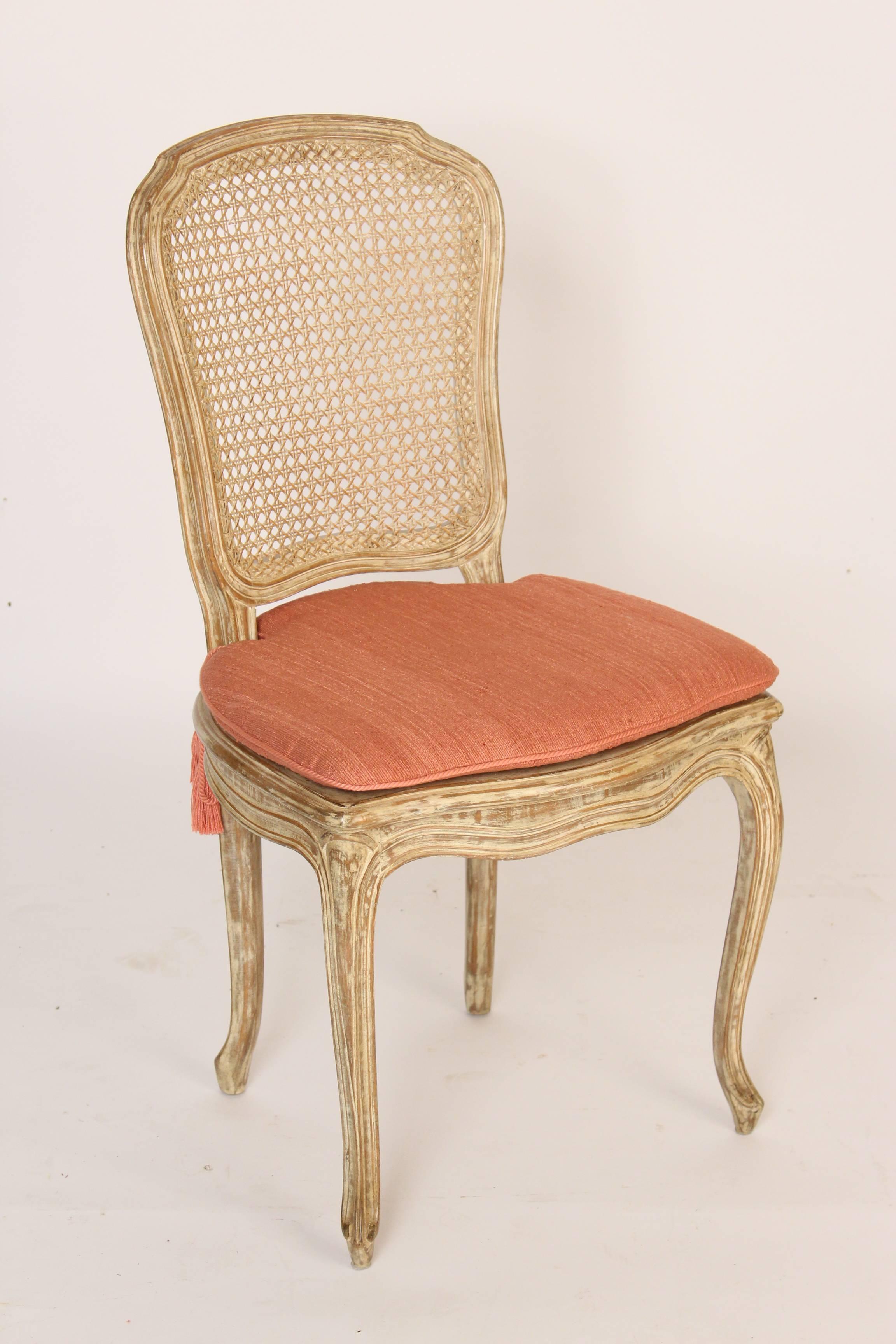 Set of ten (eight shown) painted Louis XV style dining room chairs, late 20th century. The paint has a glazed finish. All of the frames are tight. The caning on both backs and seats as well as the upholstery is in excellent condition.