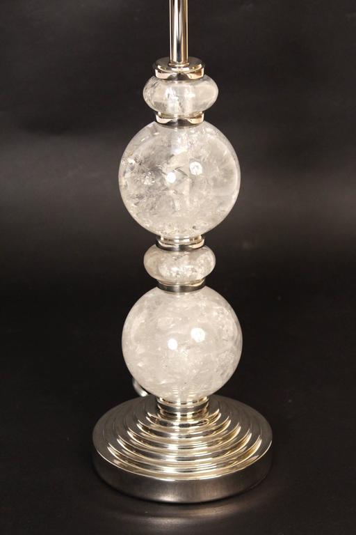 Pair of rock crystal lamps with nickel-plated fittings. The height from the base to the top of the lamp finial is 27.5
