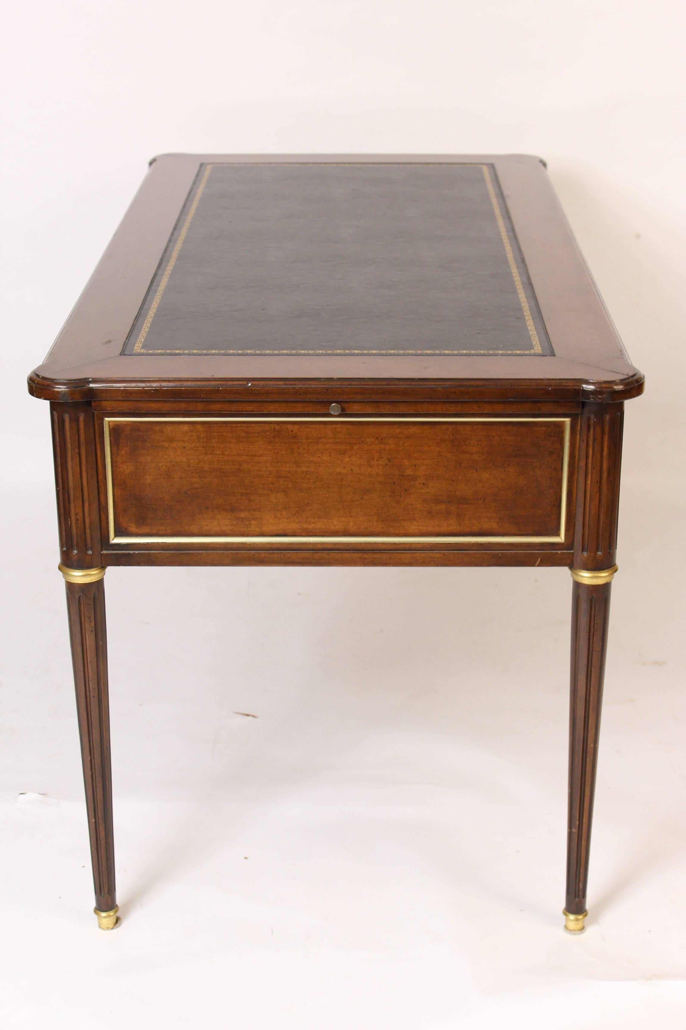 Louis XVI style brass-mounted mahogany desk with a tooled leather top made by Baker Furniture Company, circa 1990s.