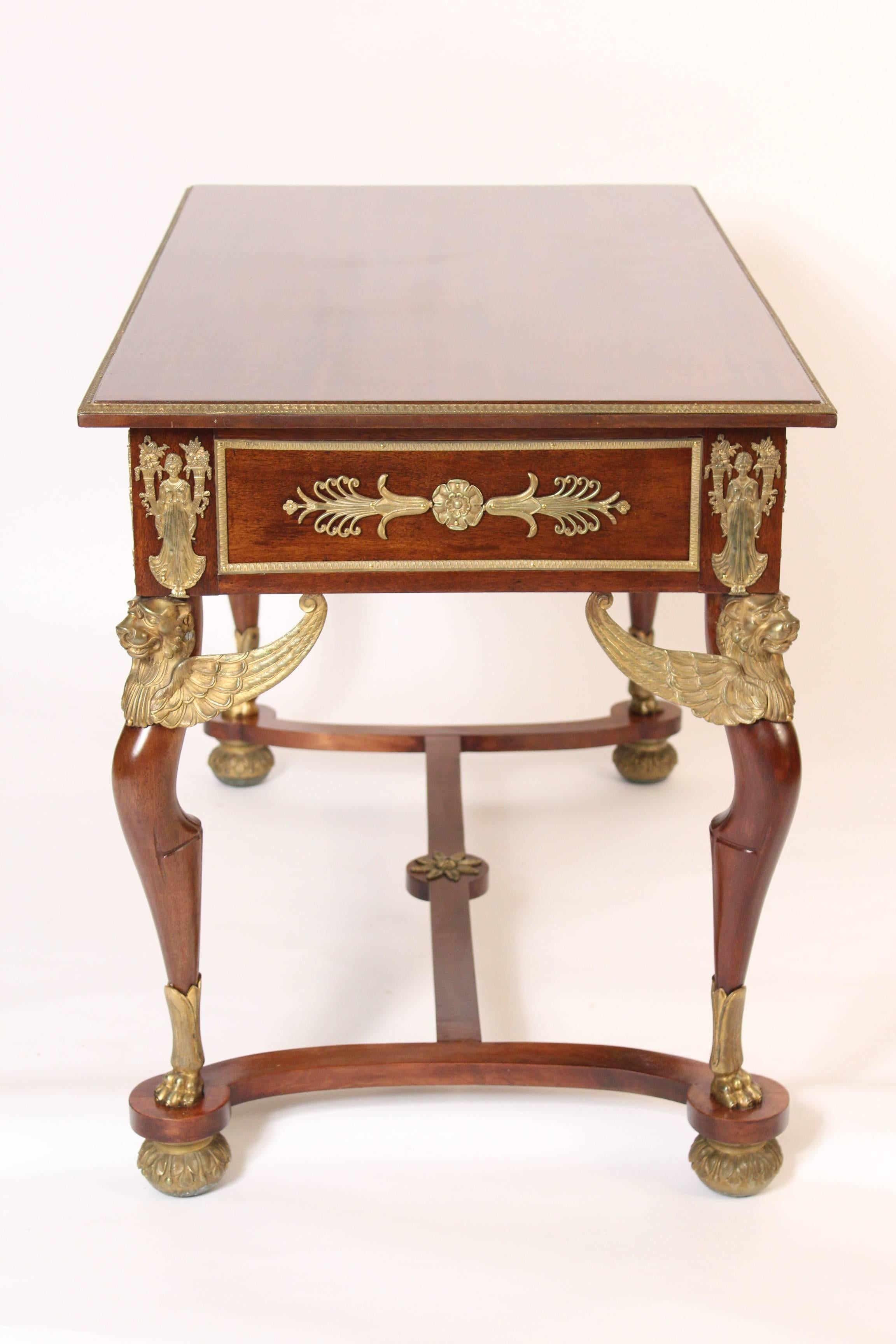 Antique Empire style mahogany desk with gilt bronze mounts, circa 1890-1910. This desk has very fine quality gilt bronze mounts.